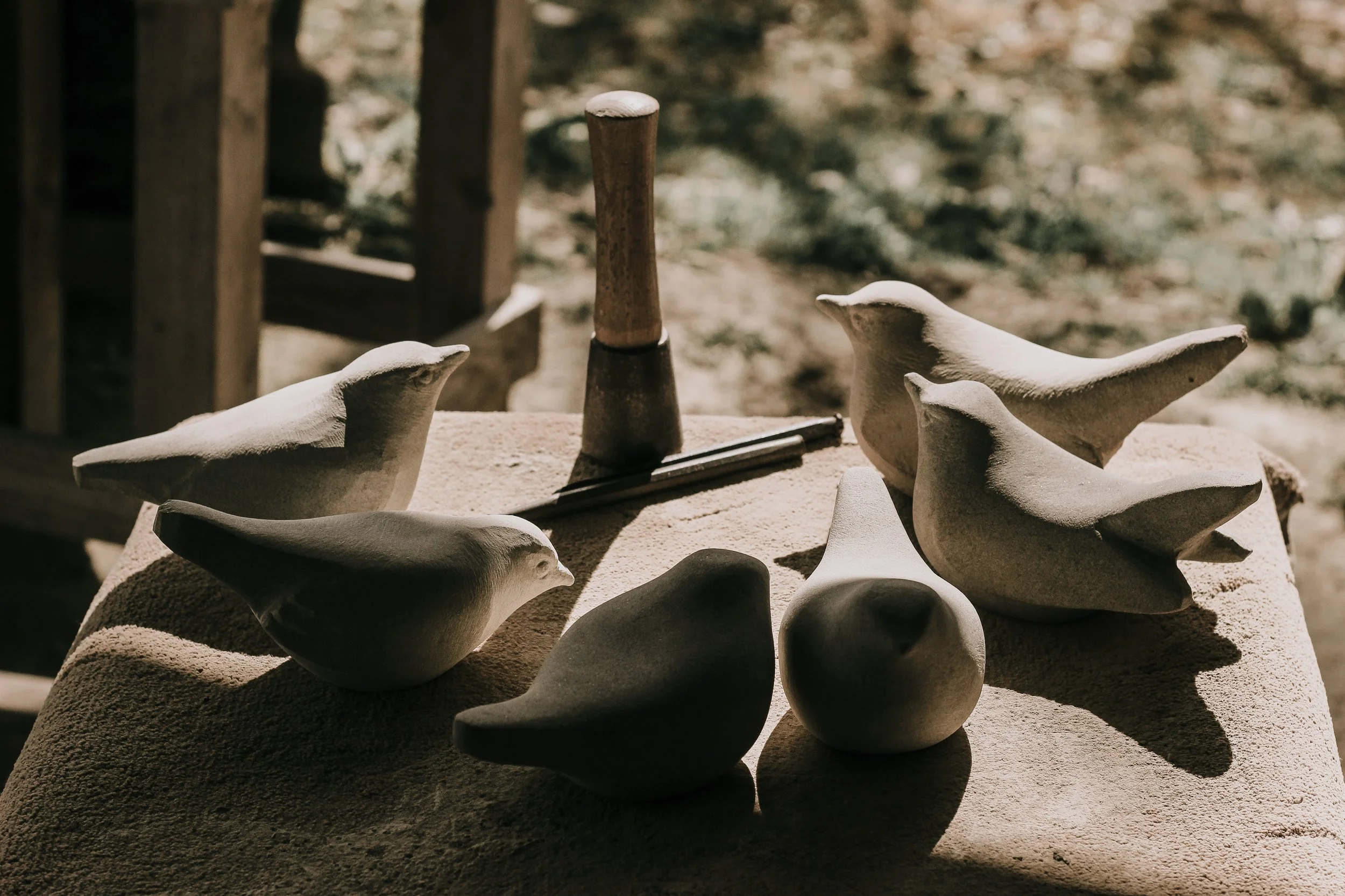 Hand carving stone birds sculpture with hammer and chisel