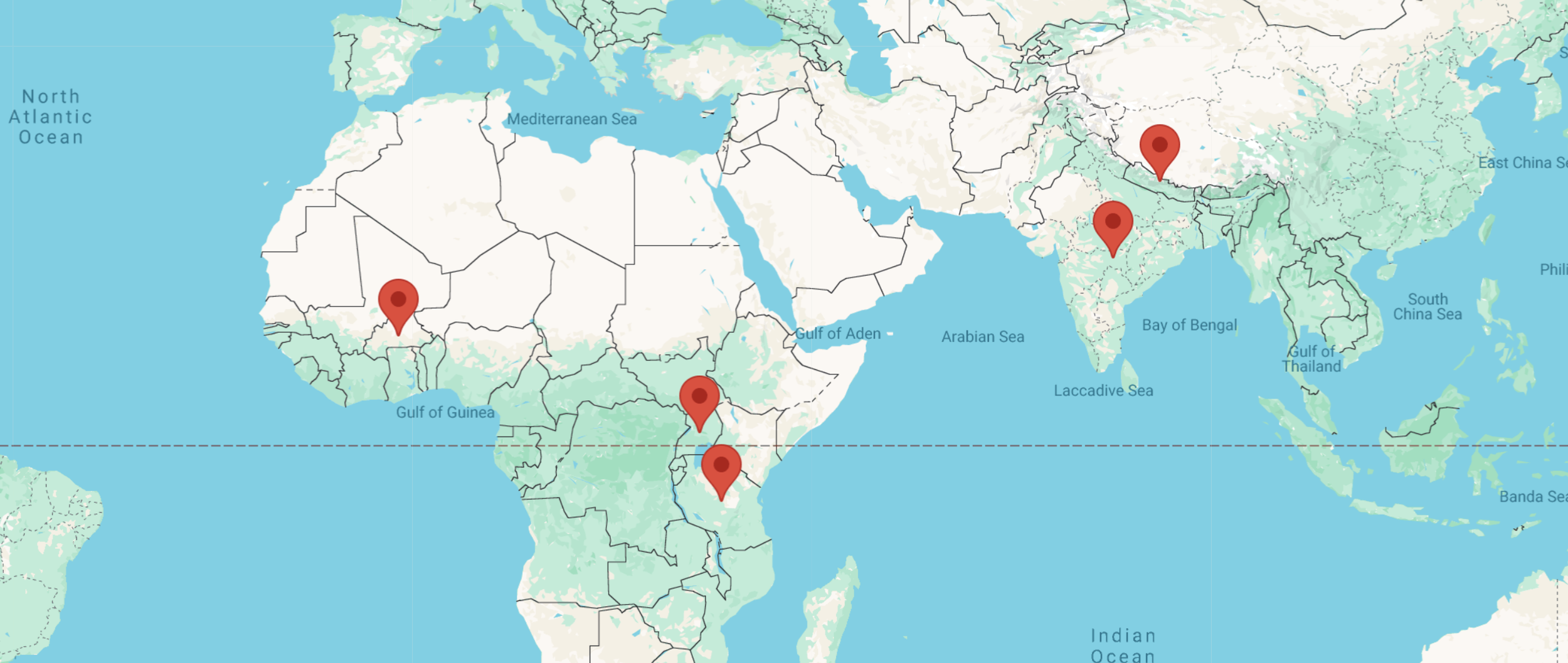 World map showing four red location markers in Africa, the Middle East, and Asia.
