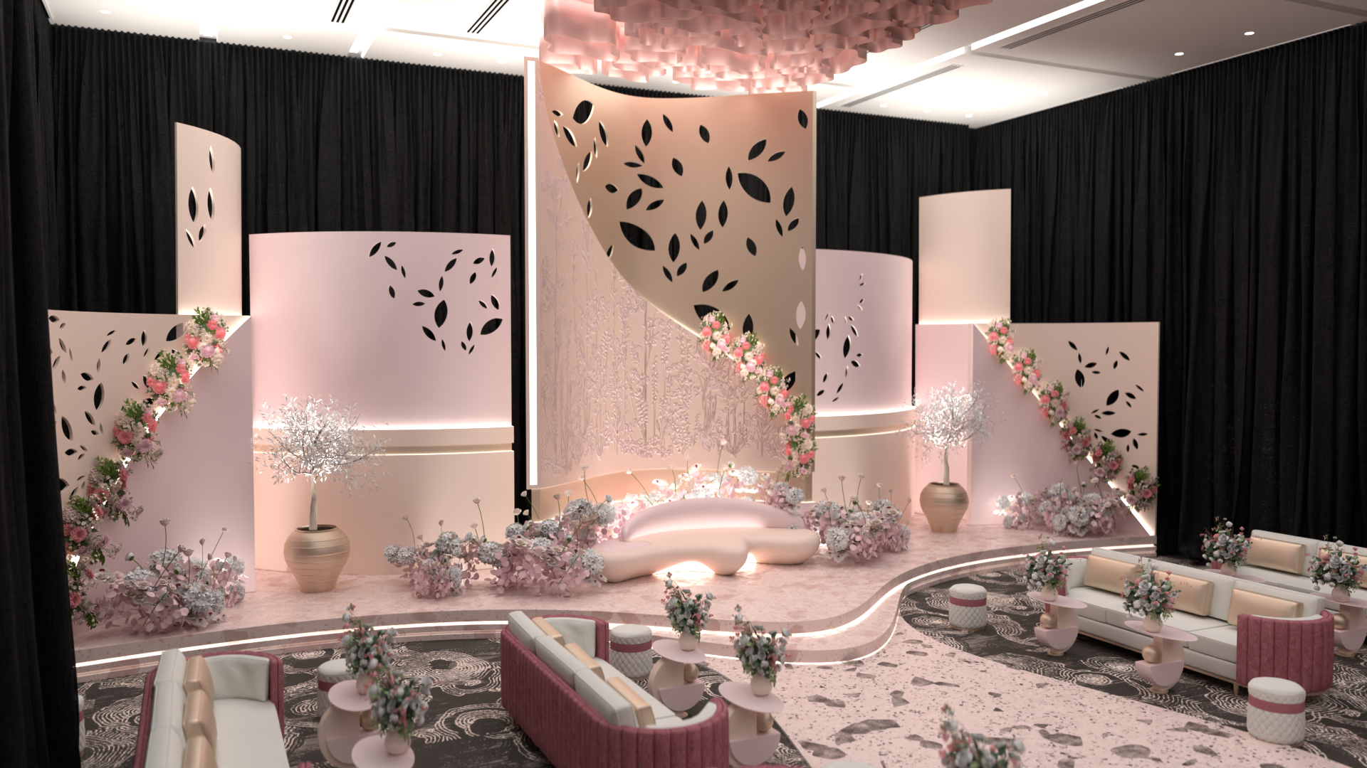 Elegant event stage with pink and white decor, floral arrangements, black curtains, and modern furniture for a celebration or wedding reception.