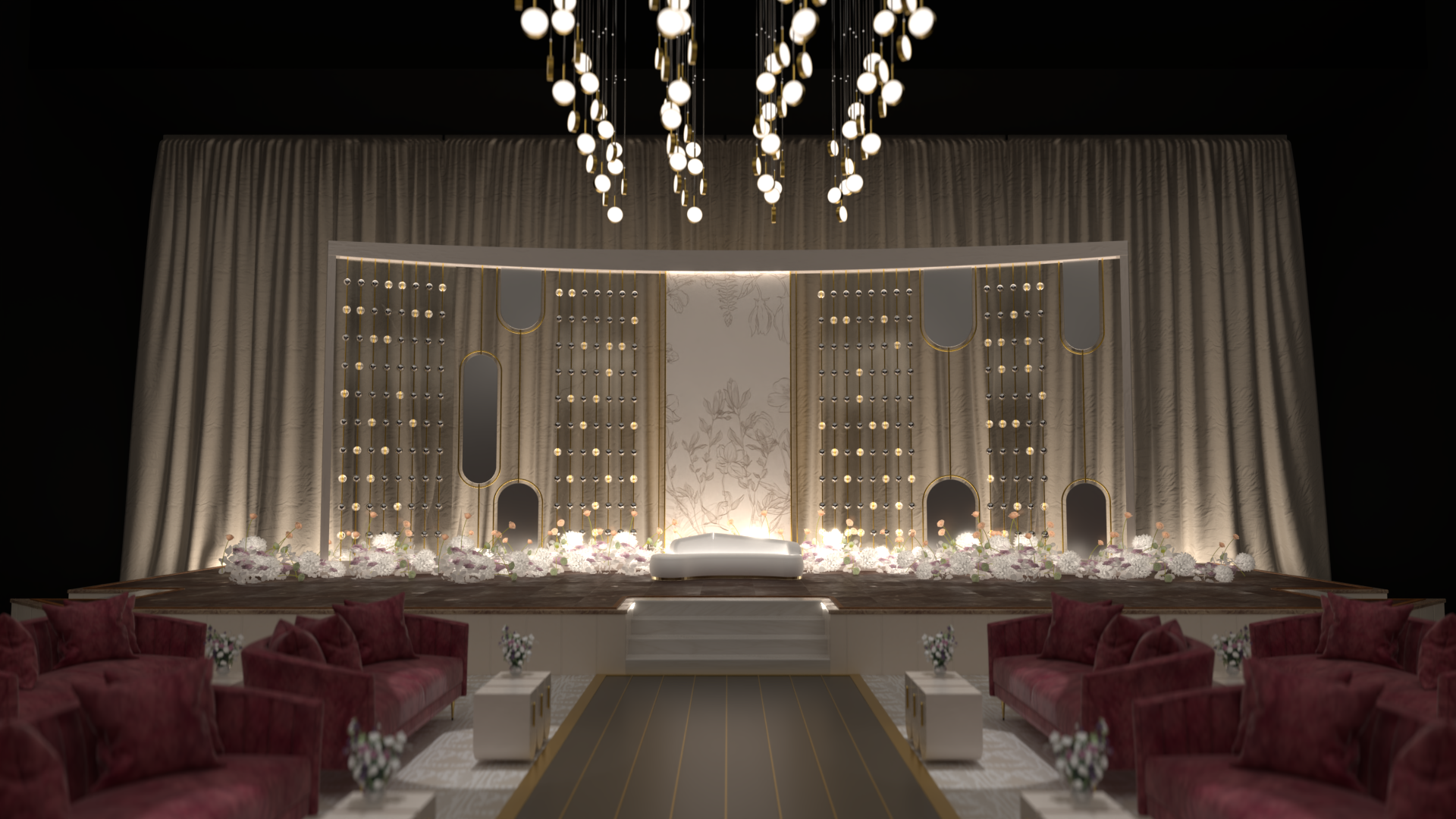 Elegant stage setup for a wedding or event with a white bed, floral arrangements, decorative backdrop, hanging lights, and red sofas with pillows in a dimly lit room.