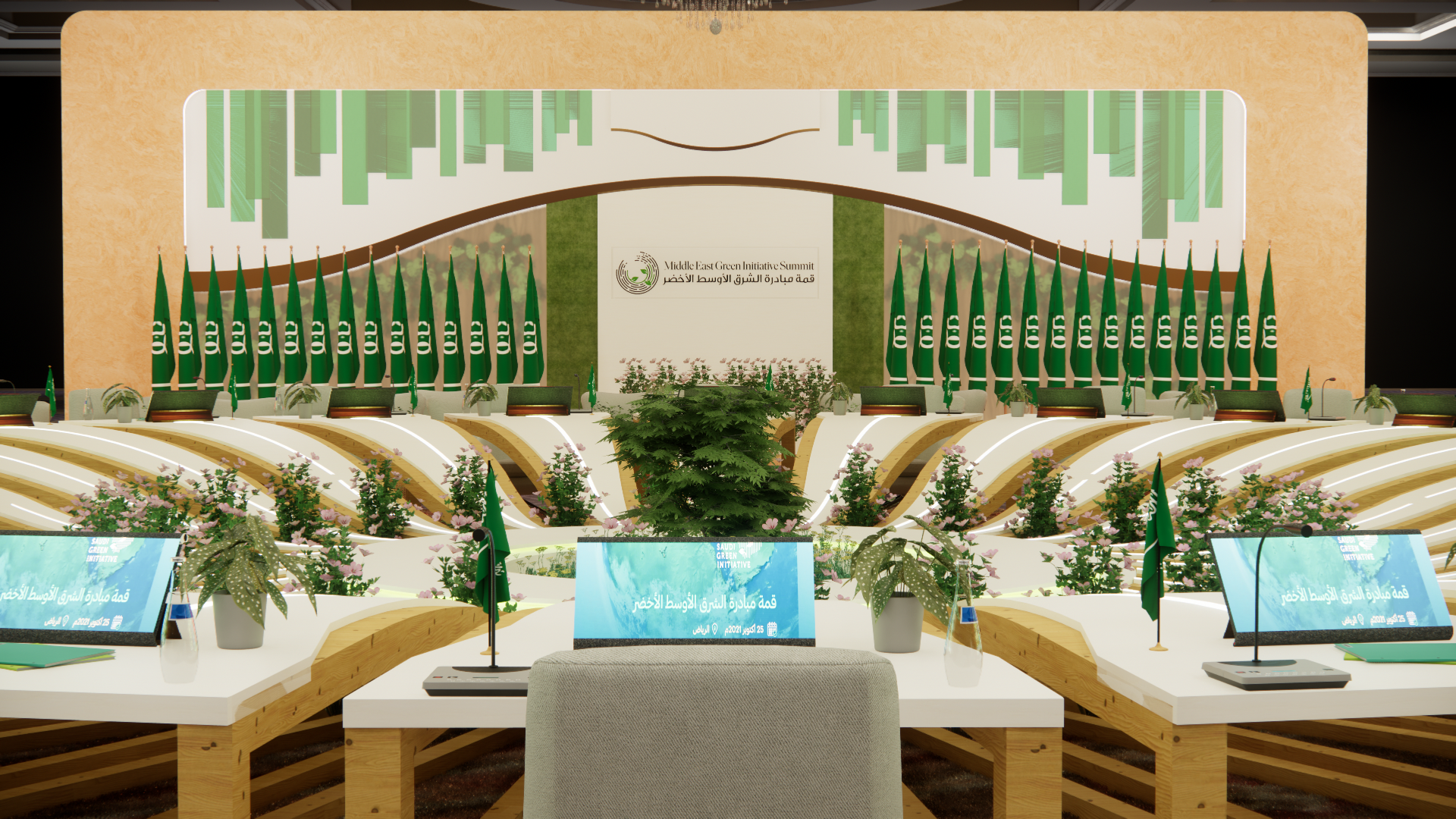 A conference stage decorated with green flags, plants, and digital screens at the Middle East Green Initiative Summit, with seating arrangements and a podium in the foreground.