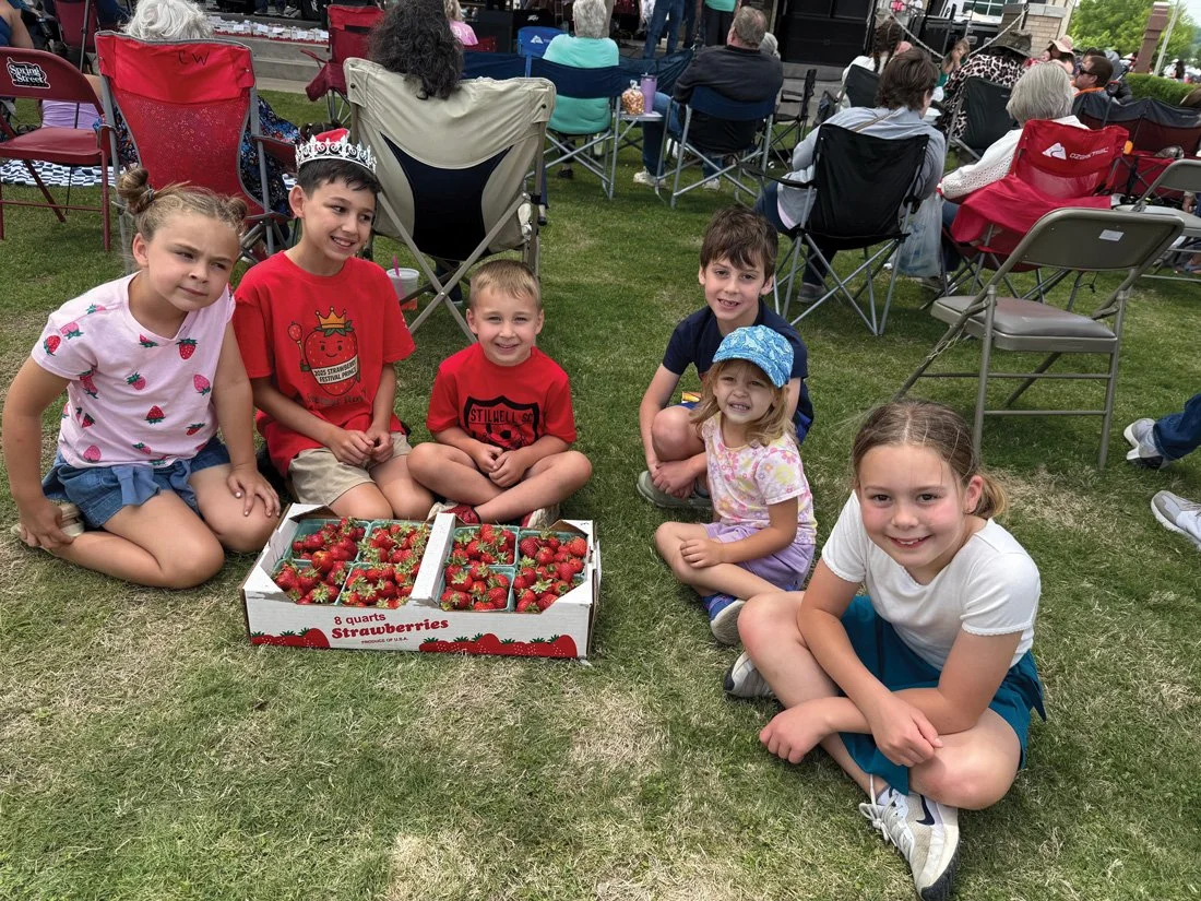   The love for Stilwell strawberries starts young. Alivia Davis, Arden Davis, Asa Davis, Nora Felice, Carson Salomon and Caleb Felice enjoy the 2025 festival.  (Photo by Andy Massie.)   
