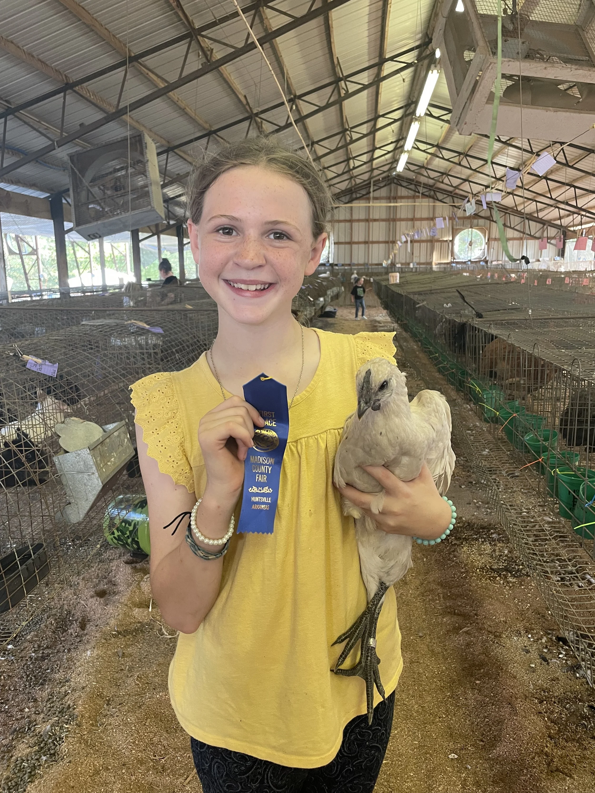  Wyn Yancey with her Pearl Onyx chicken, Britni, at the Madison County Fair. 