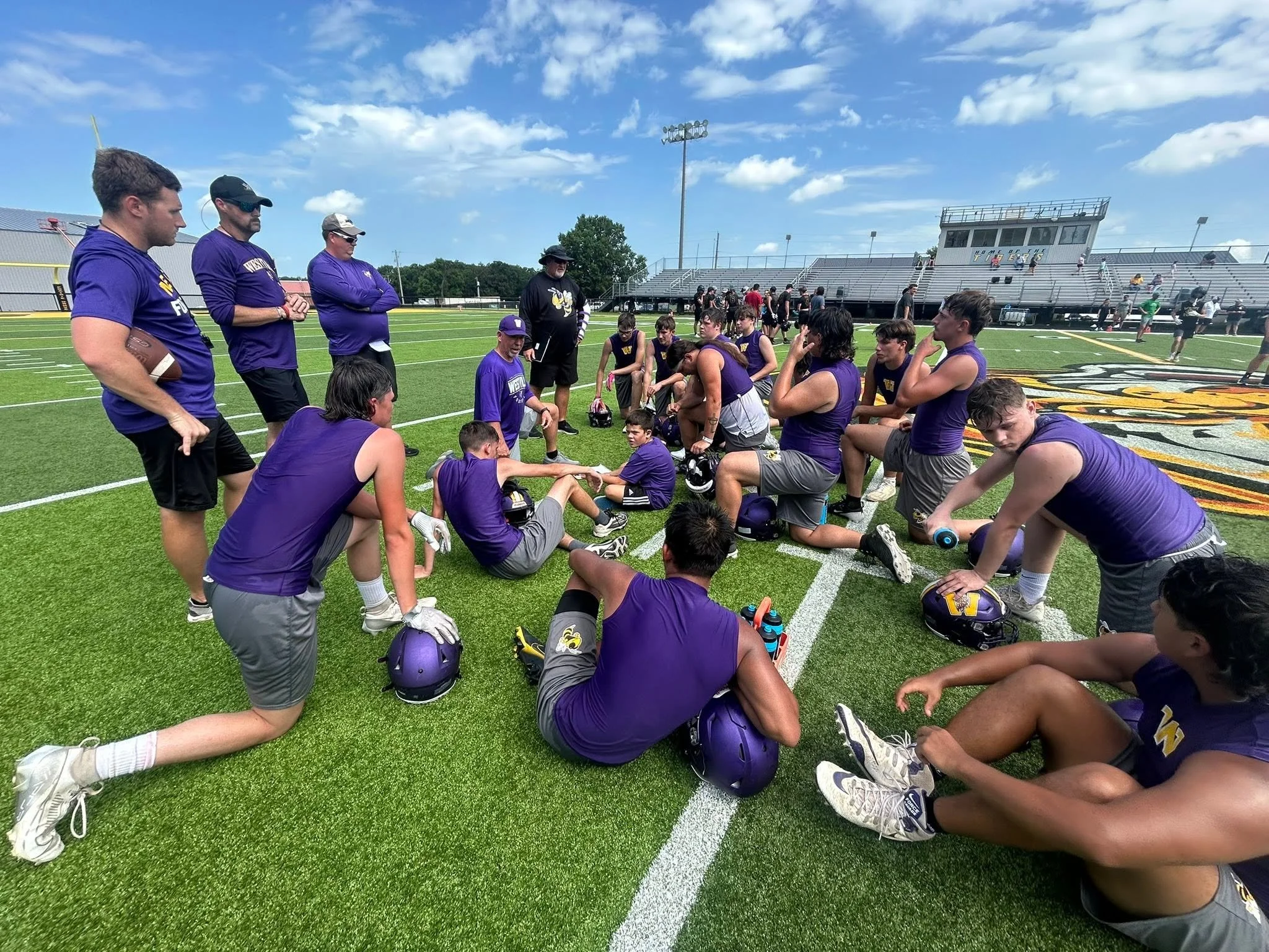  Westville High School players listen to coaches at a practice this summer.  (Photo by Travis Cloud)  