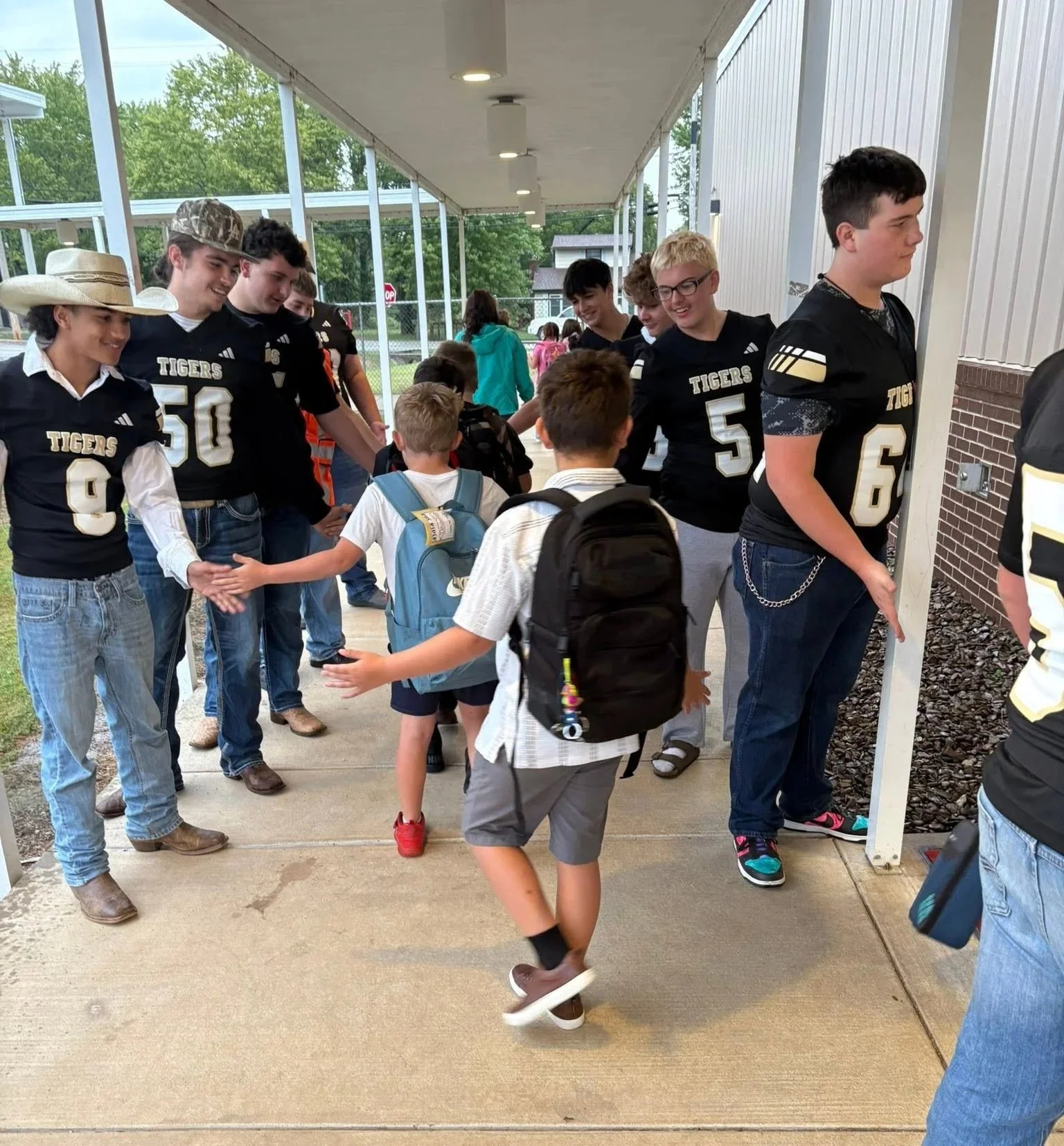  High Five Fridays are a way to keep West Fork football players involved with younger students.  (Photo by Michelle Posey) . 