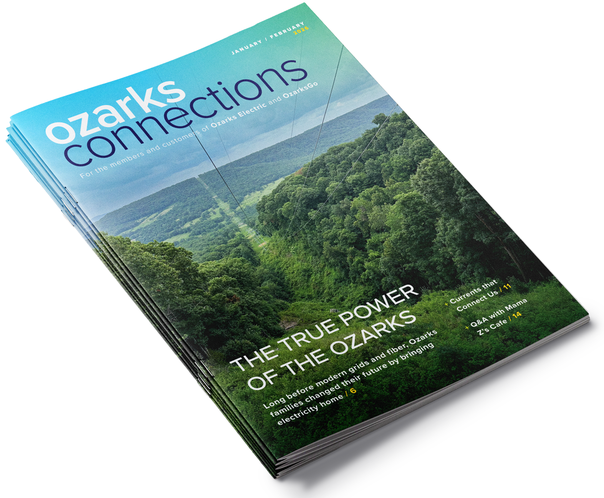 A magazine titled "Ozarks Connections" with a cover photo of the green, forested Ozarks mountains and a clear sky. The cover features headlines about the power of the Ozarks, including topics like modern electric grids, community connections, and a cafe.