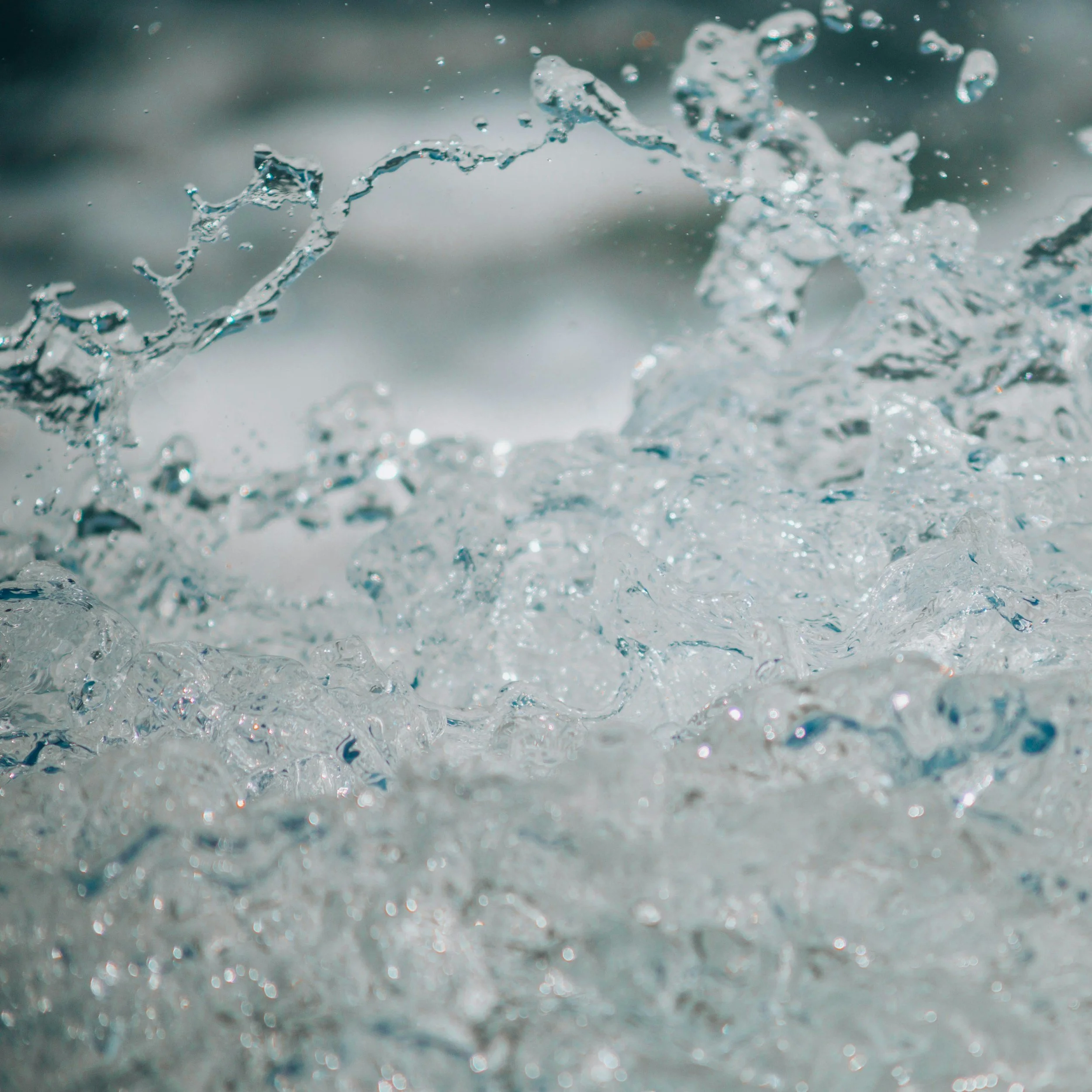 Close-up of splashing water with bubbles and droplets in motion.