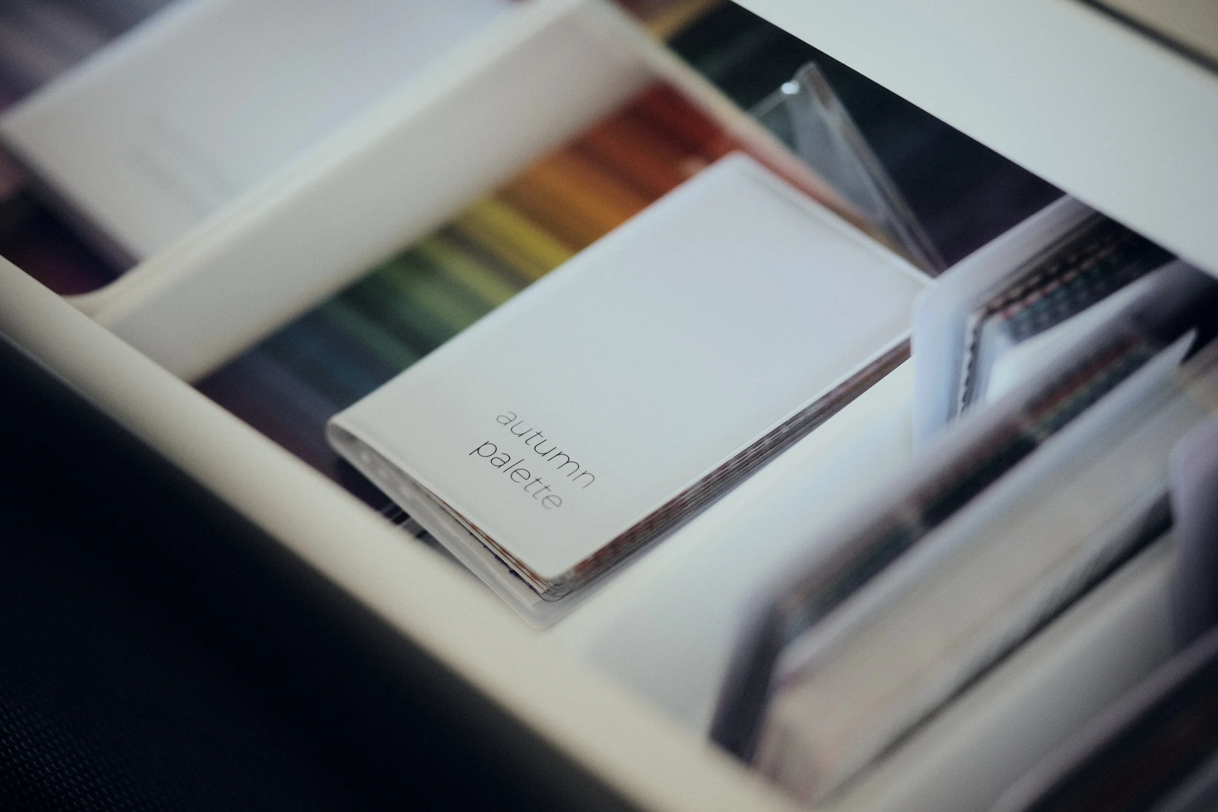 Display of fabric swatches in various colors including shades of pink, red, blue, green, gray, and black, including some Solid, Satin, and Velvet textures.