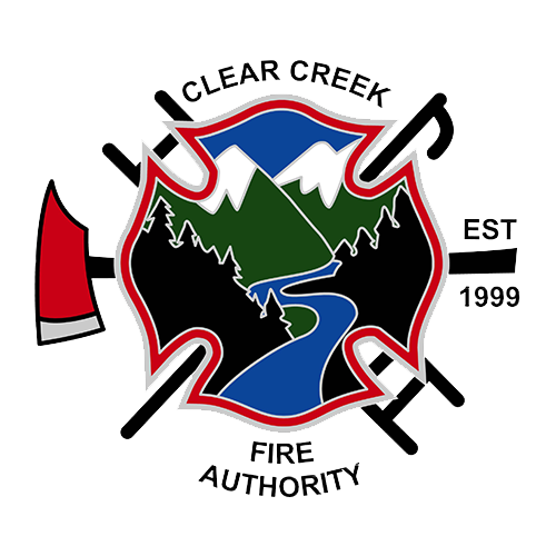 Logo of Clear Creek Fire Authority featuring a shield with mountains, a river, and trees, surrounded by firefighting tools like axes and a fire axe, with a red fire hydrant on the left and text indicating establishment in 1999.