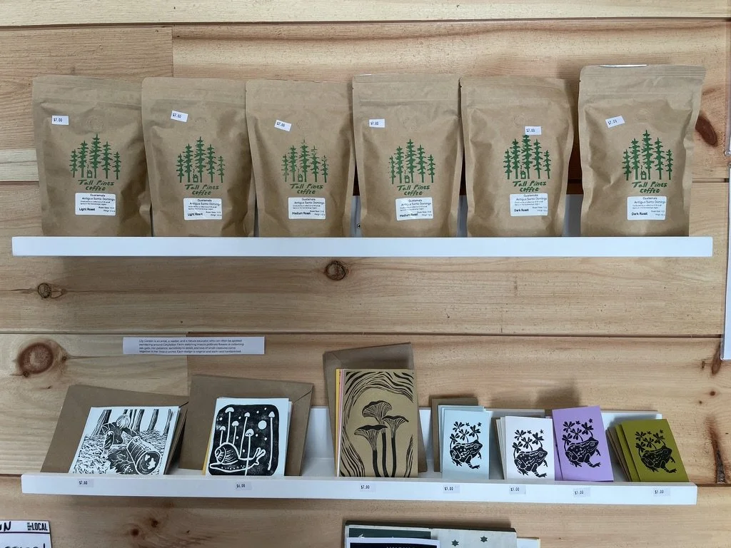 Tall Pines Coffee bags and printed cards at farm store