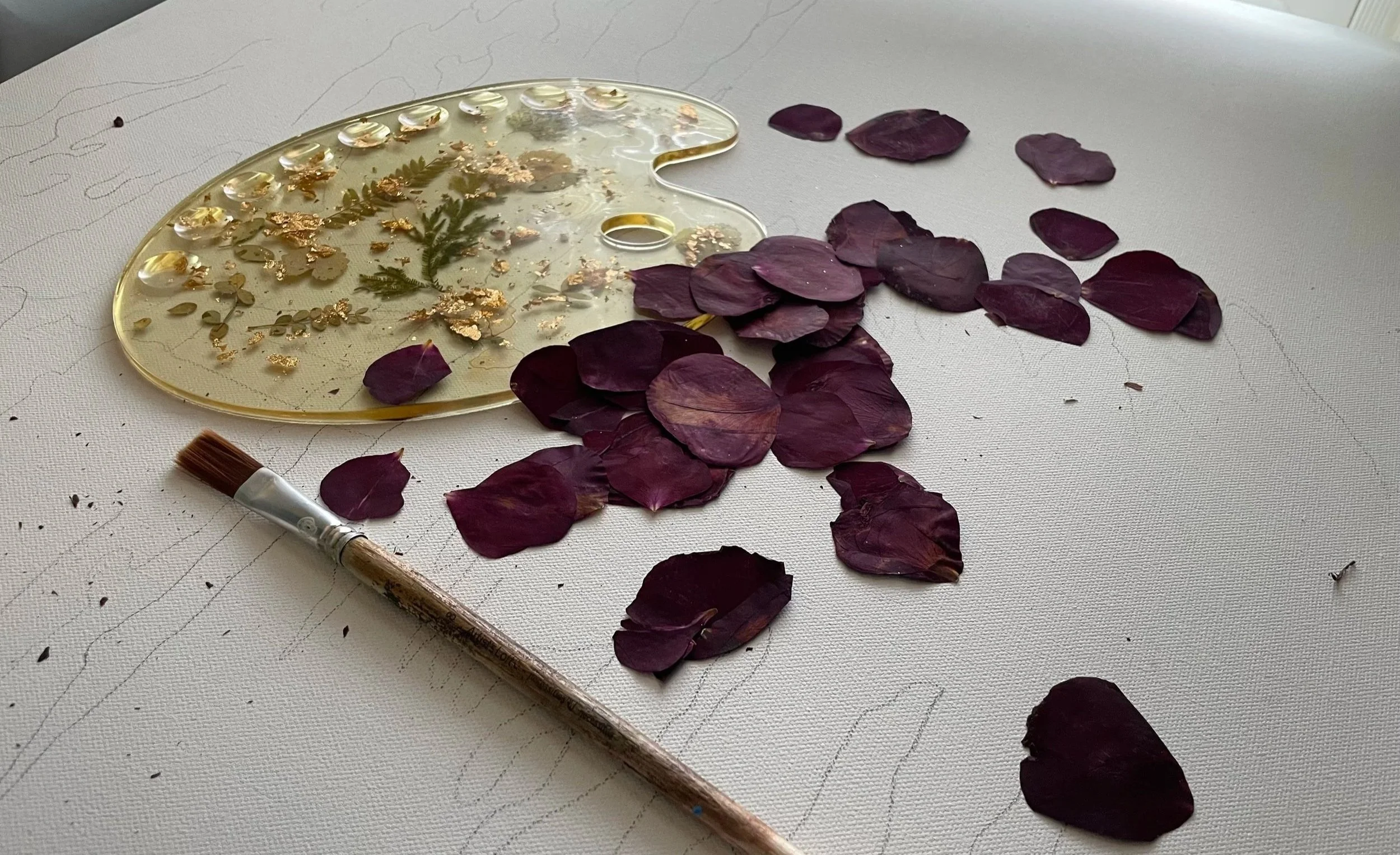 Wedding petals prepared for pressed flower preservation beside a discolored resin palette used in wedding bouquet preservation.