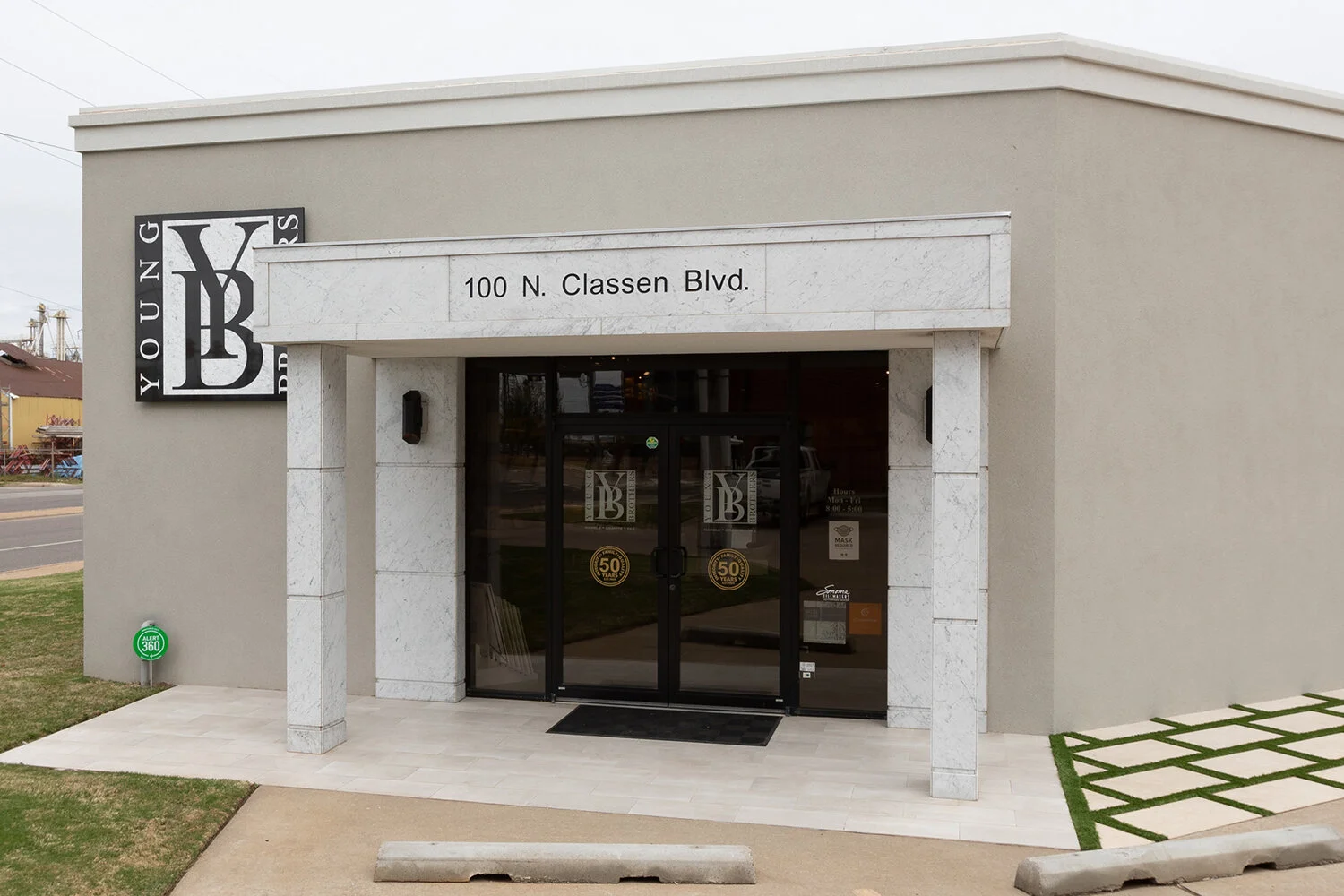 Exterior of a building at 100 N. Classen Blvd with a sign for Youngers Building and glass doors.