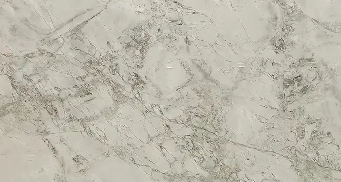 Close-up view of a marble surface with light beige and gray veining.