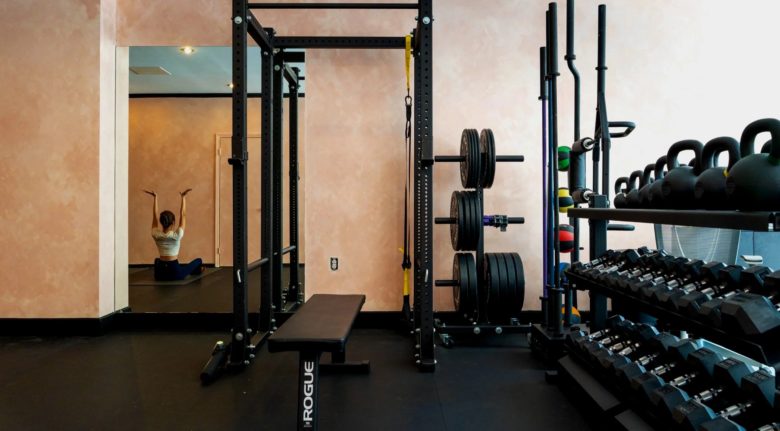Health coach Maggie Ng performing an ELDOA exercise to decompress her spine at the end of a workout session. 
