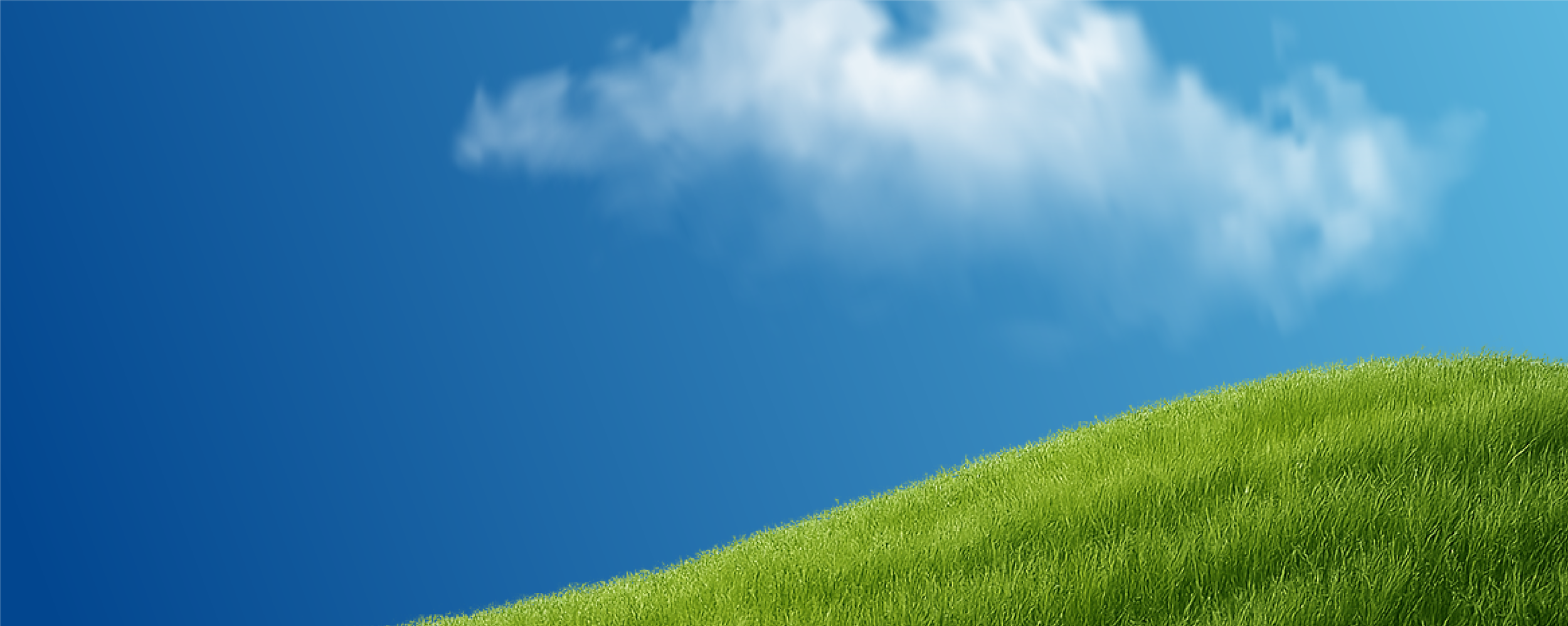 Green grassy hill under a bright blue sky with a few scattered white clouds.