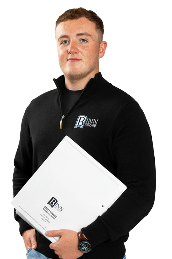A young man with short brown hair, wearing a black jacket with a "B Inn Group" logo, holding a large white binder, standing against a white background.