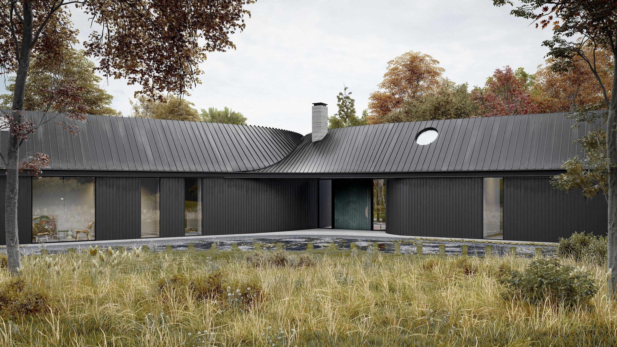 The Y house has a curved roof, large windows, and a central chimney tucked behind the main entrance. It's located in a natural landscape with trees and grassy foreground.