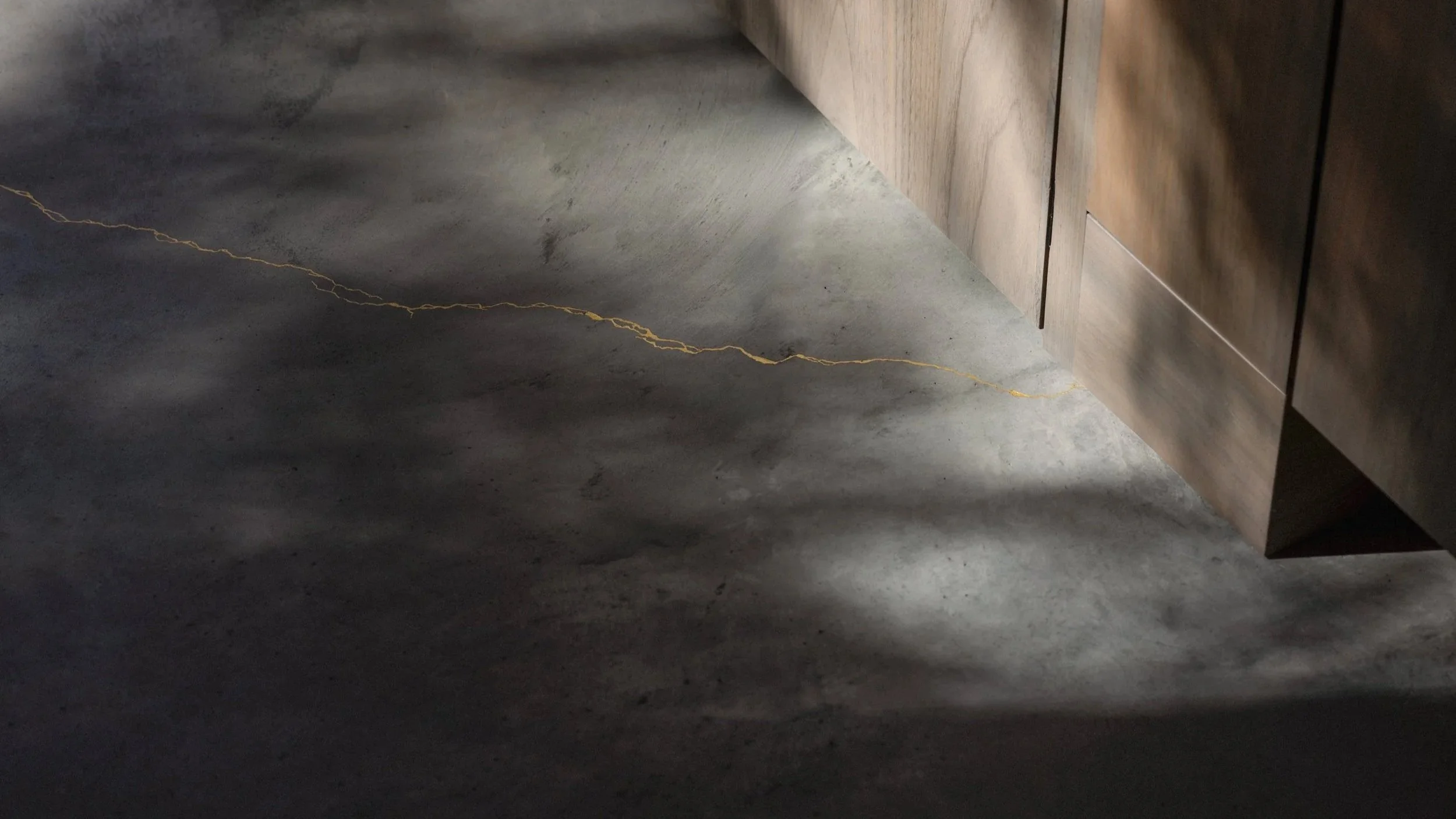 Kintsugi detailing with real gold leaf on concrete floor - details with utmost care