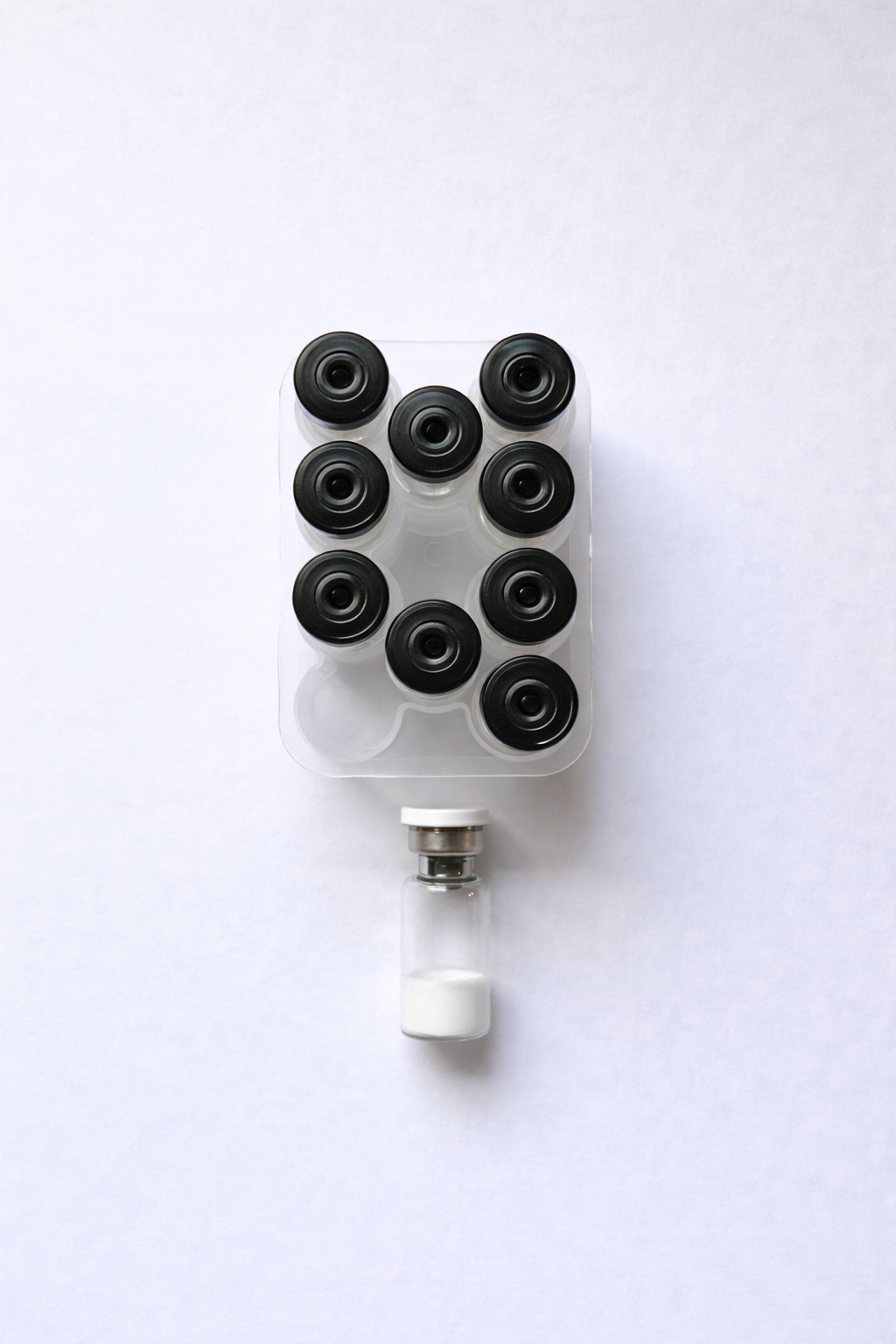 Neatly arranged glass vials on tray.png