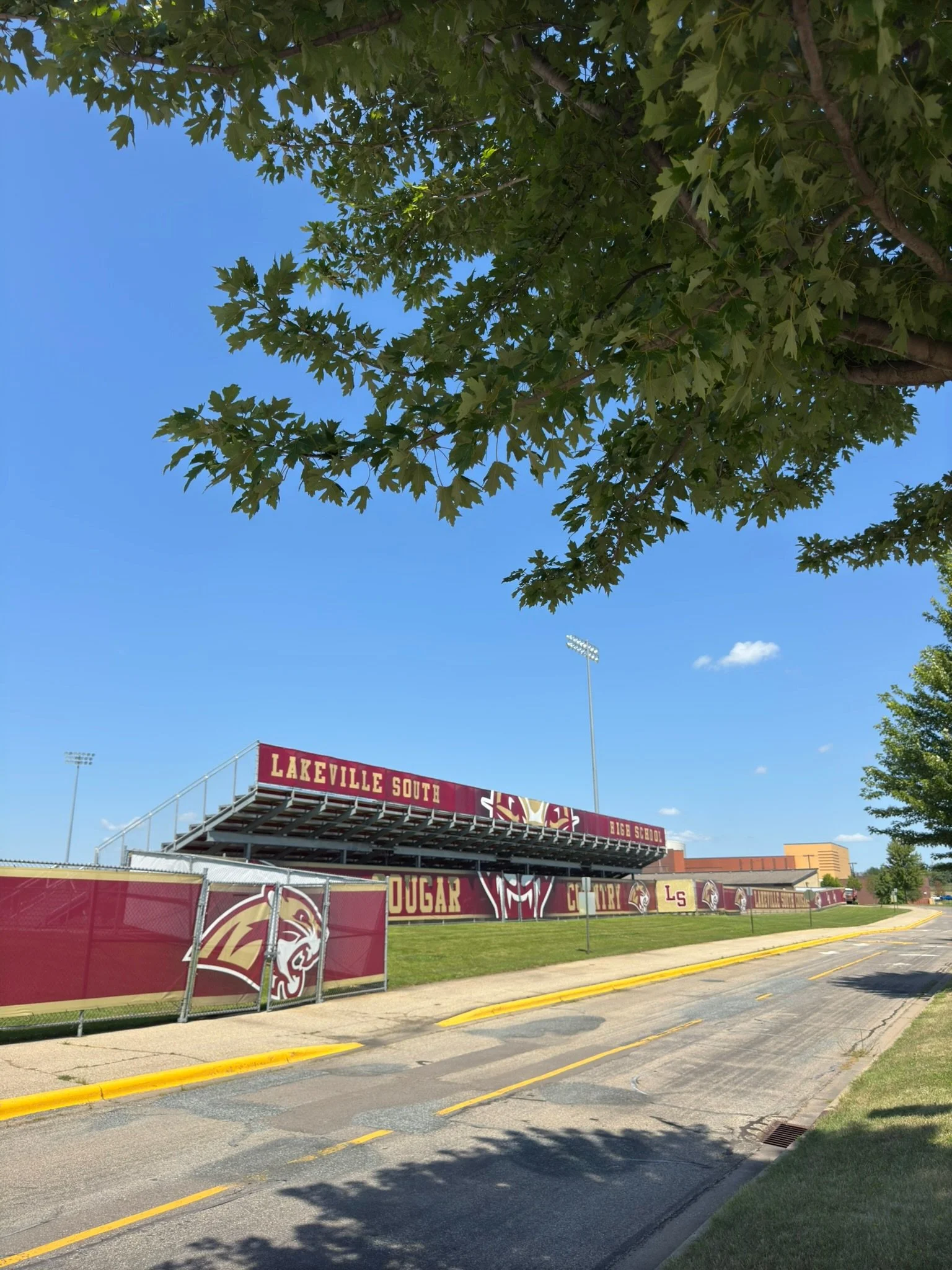 View of a high school football field bleachers with signs saying 