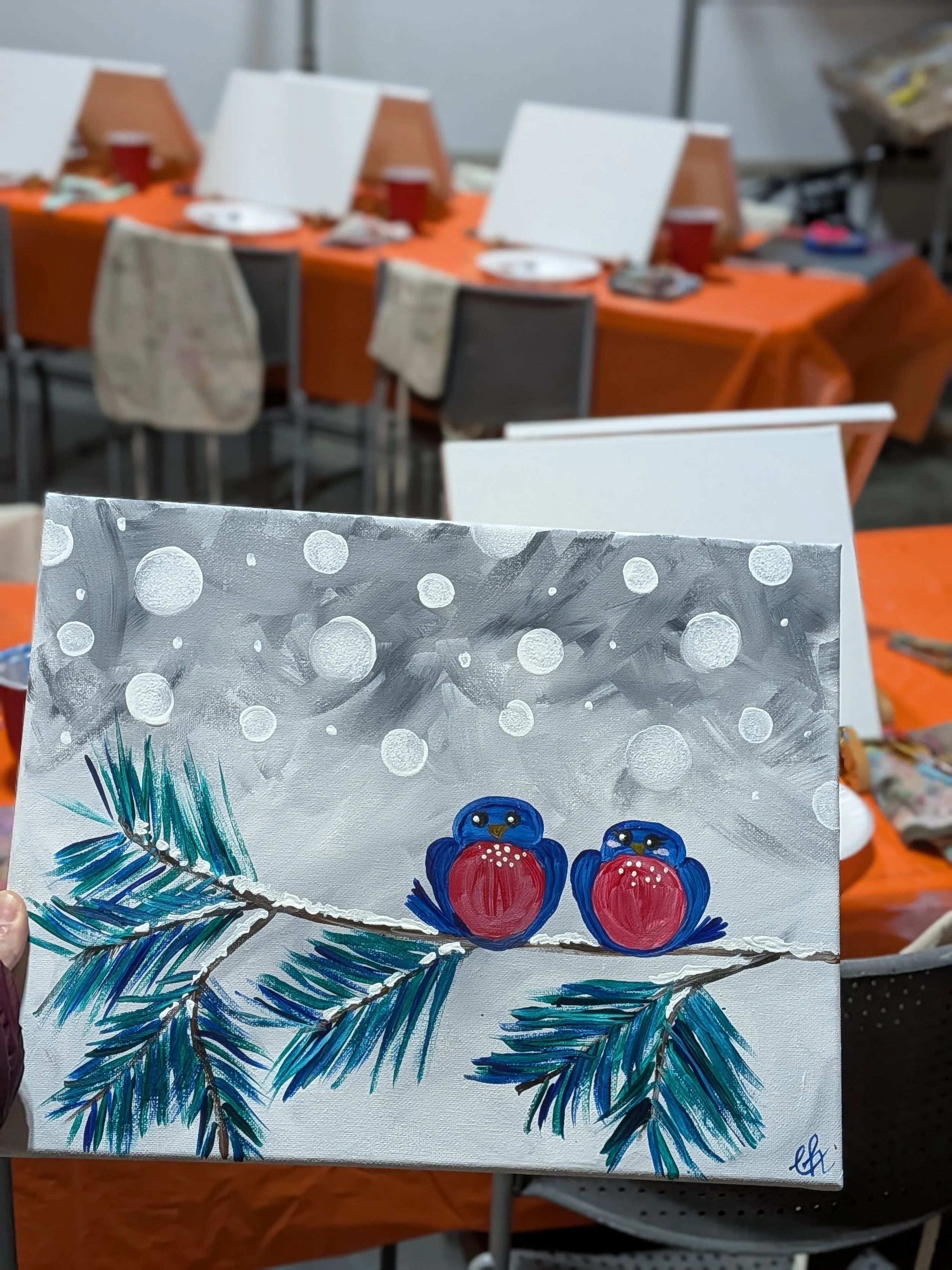 Painting of two blue birds with red breasts sitting on a pine branch, with a snowy background and snowflakes falling.