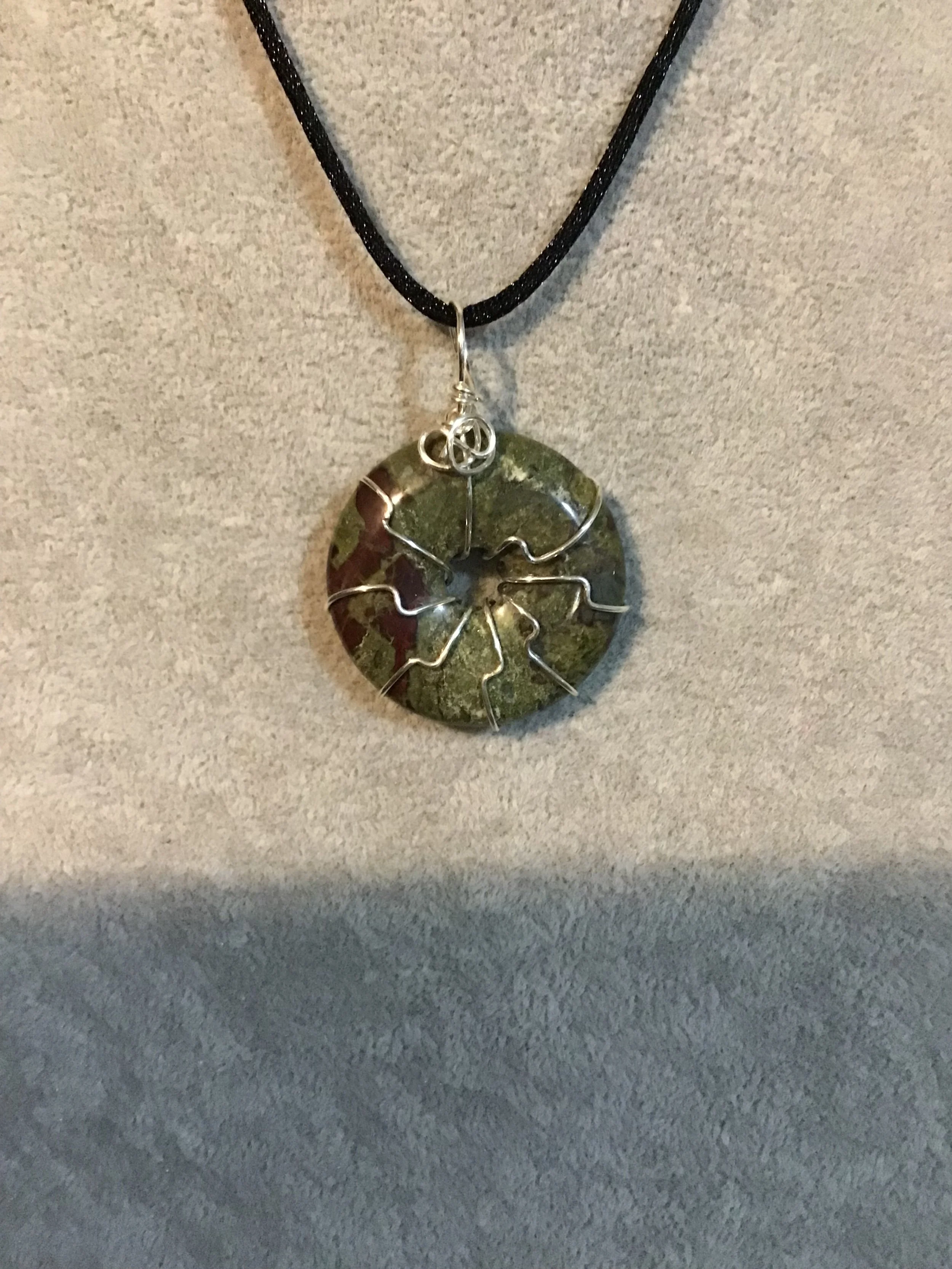 Wire wrapped Dragon Blood Jasper gemstone donut on18 black satin adjustable cord