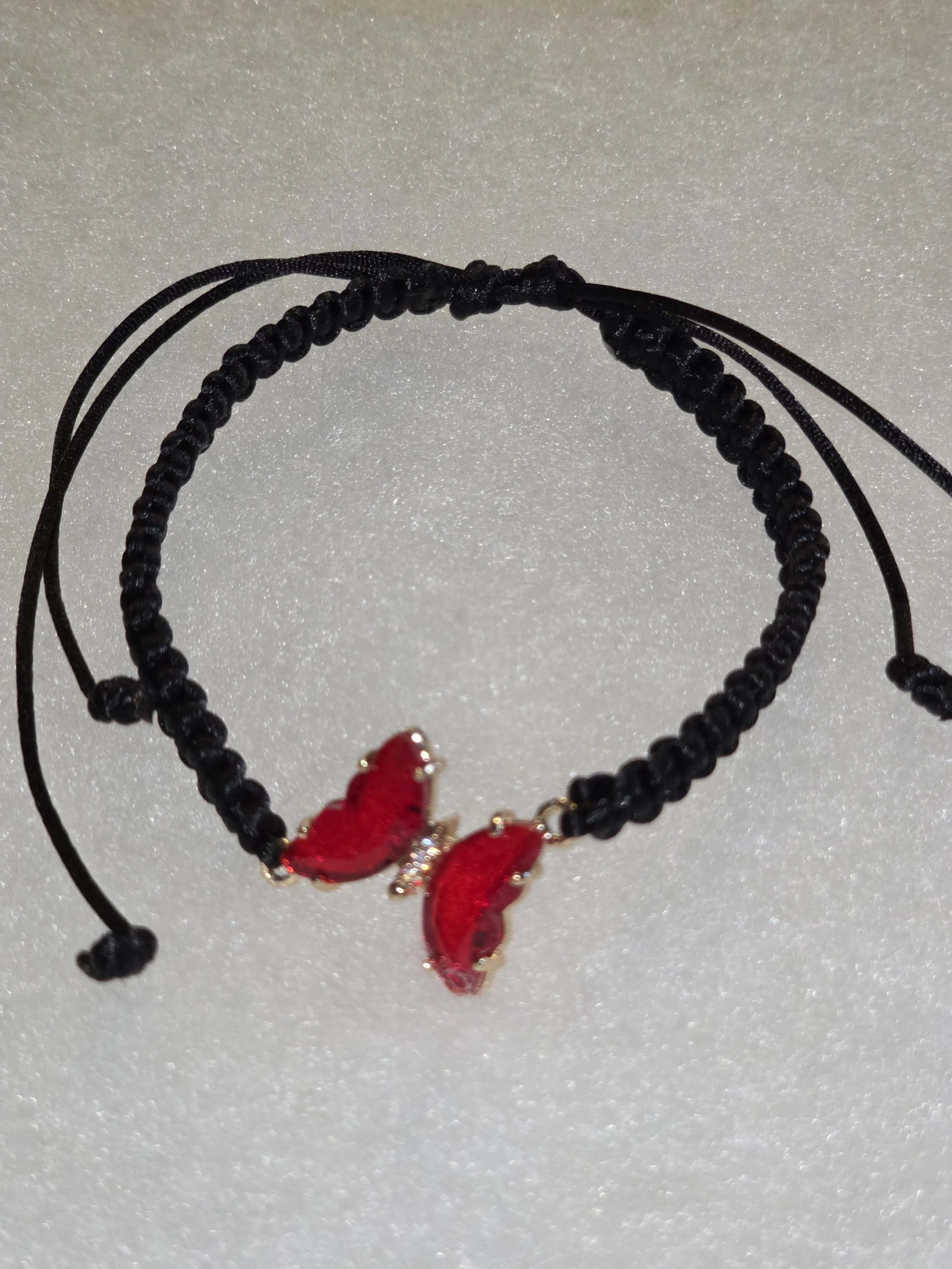 Hand woven black macrame bracelet with red crystal butterfly