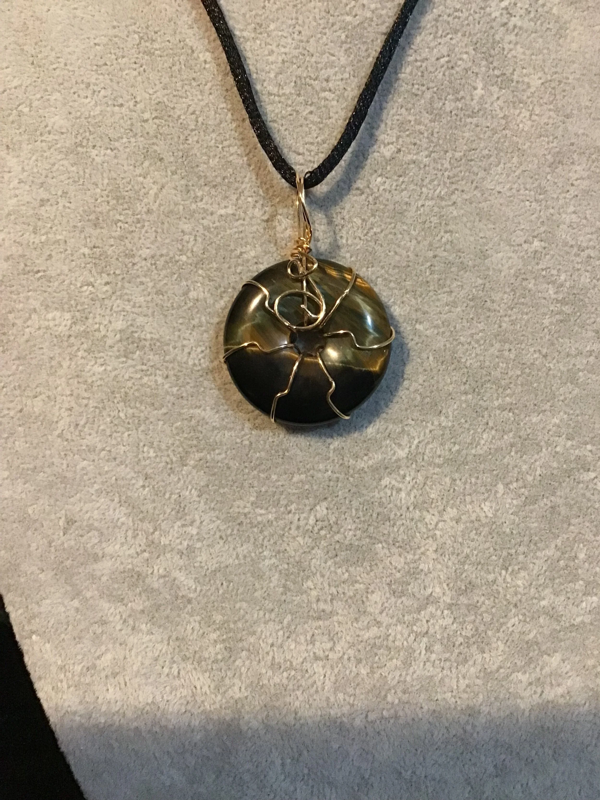 Wire wrapped Golden Blue Tiger Eye gemstone donut on18 black satin adjustable cord
