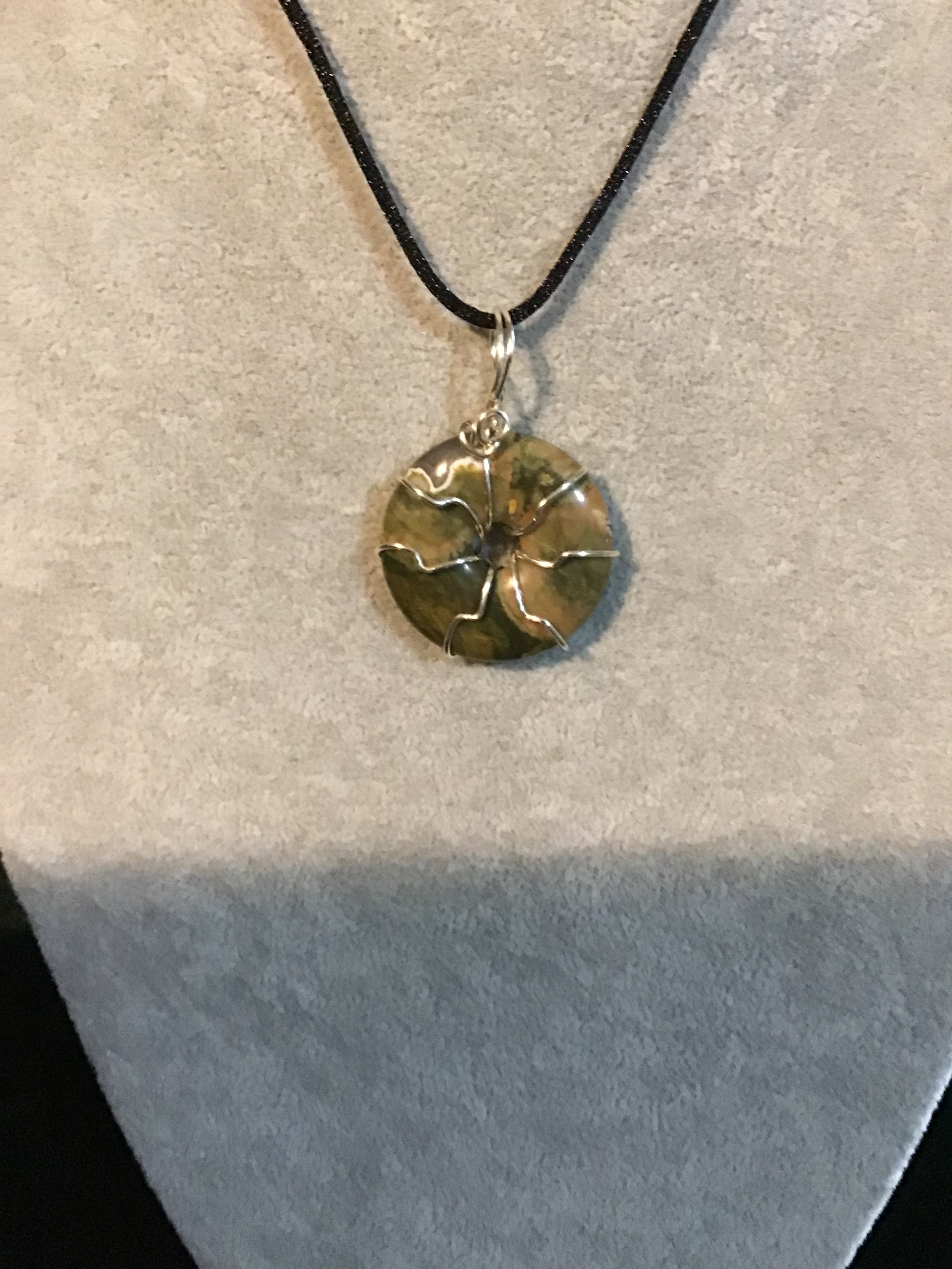 Wire wrapped Rhyolite gemstone donut on18 black satin adjustable cord