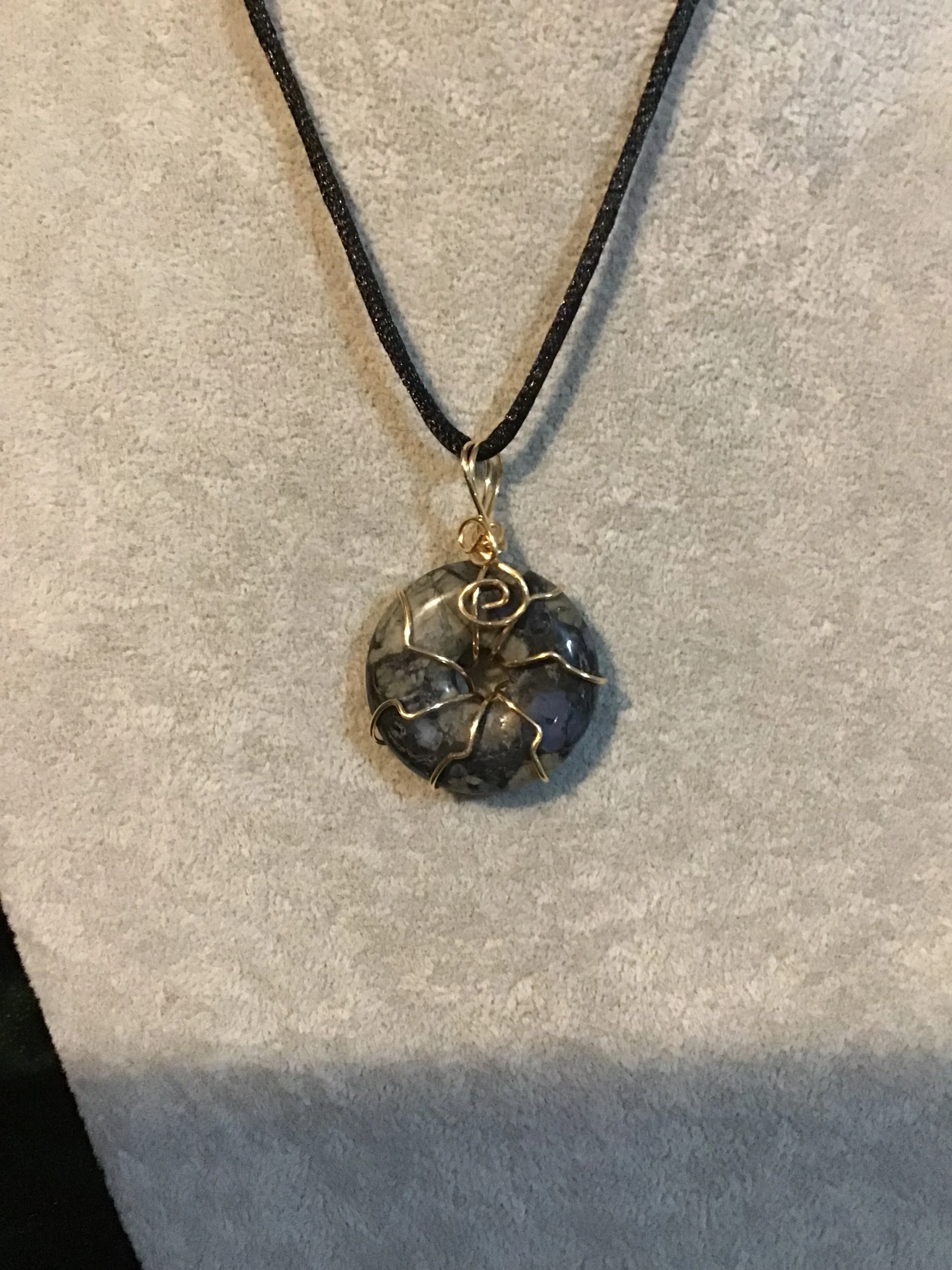 Wire wrapped Lianite gemstone donut on18 black satin adjustable cord