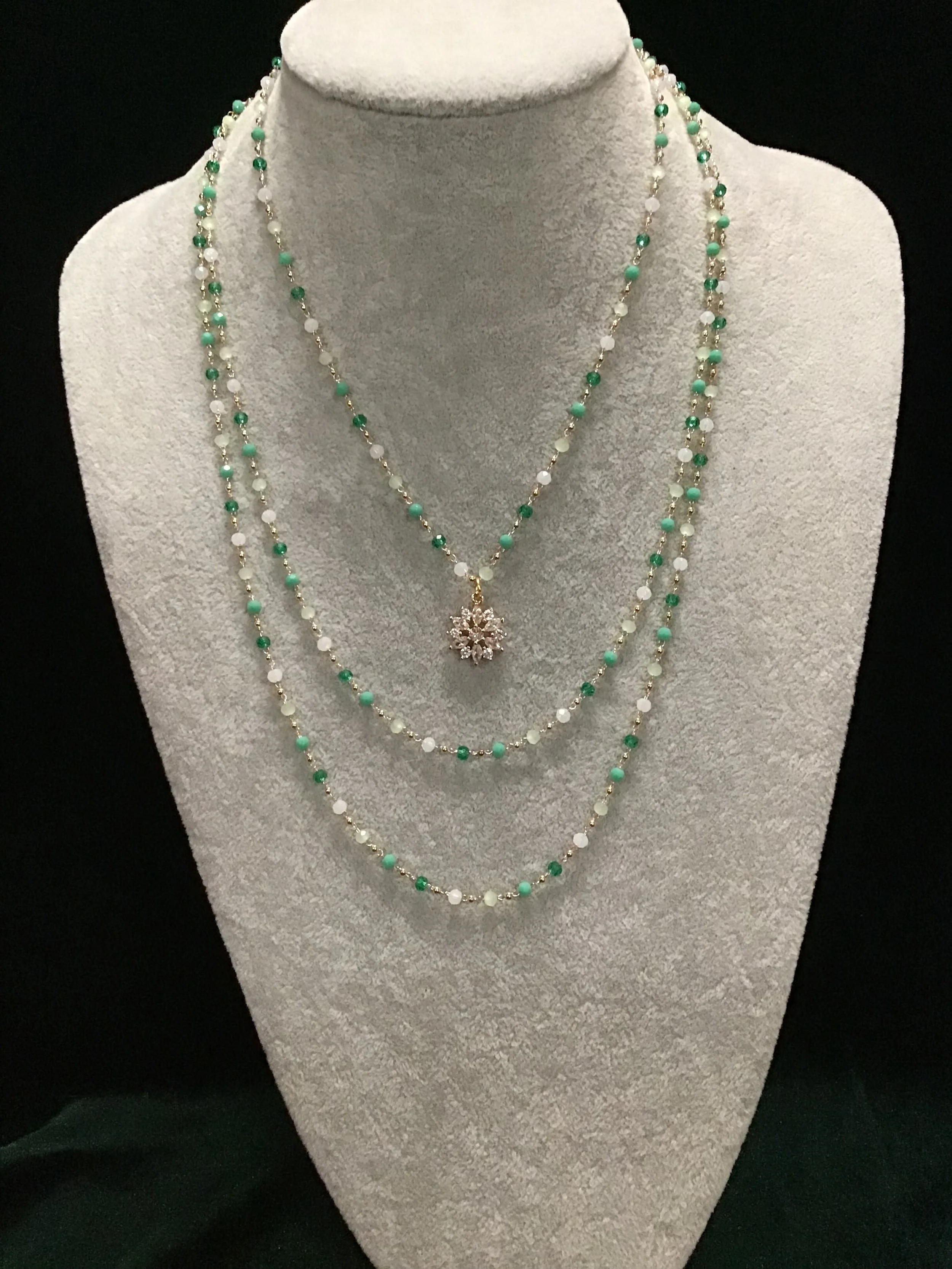 Multi-strand necklace with snowflake centerpiece