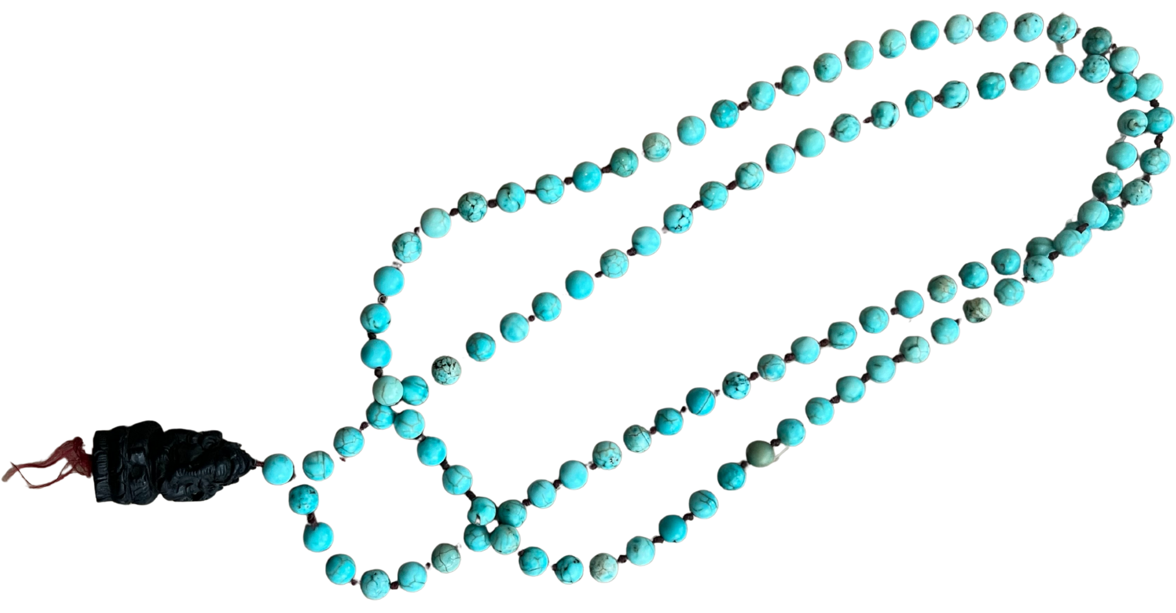 A turquoise mala beaded necklace with a carved black pendant on a red string.