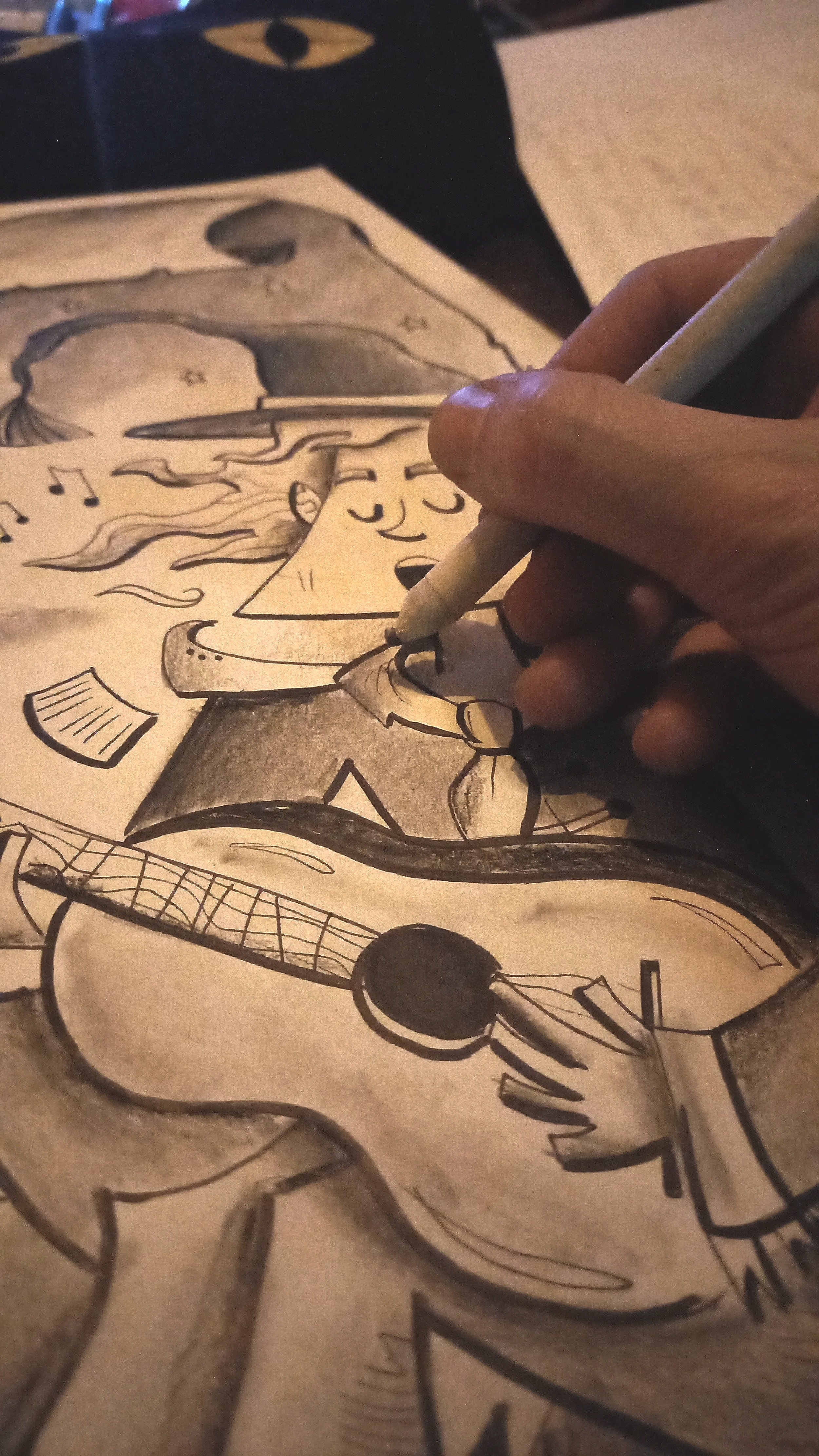 A person is coloring a whimsical drawing of a girl with long hair playing an acoustic guitar, with musical notes and abstract shapes around her.