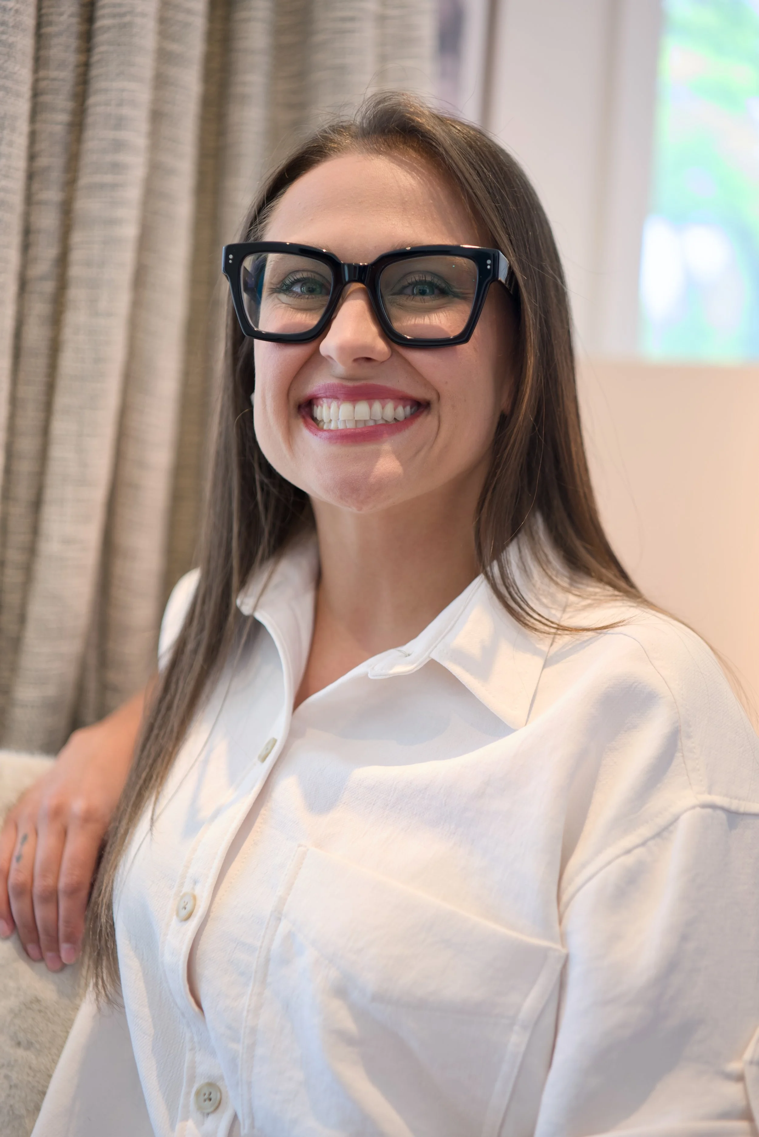 Alexandra Popova, APRN, Psychiatry Provider | Alexandra smiling at the camera, wearing glasses