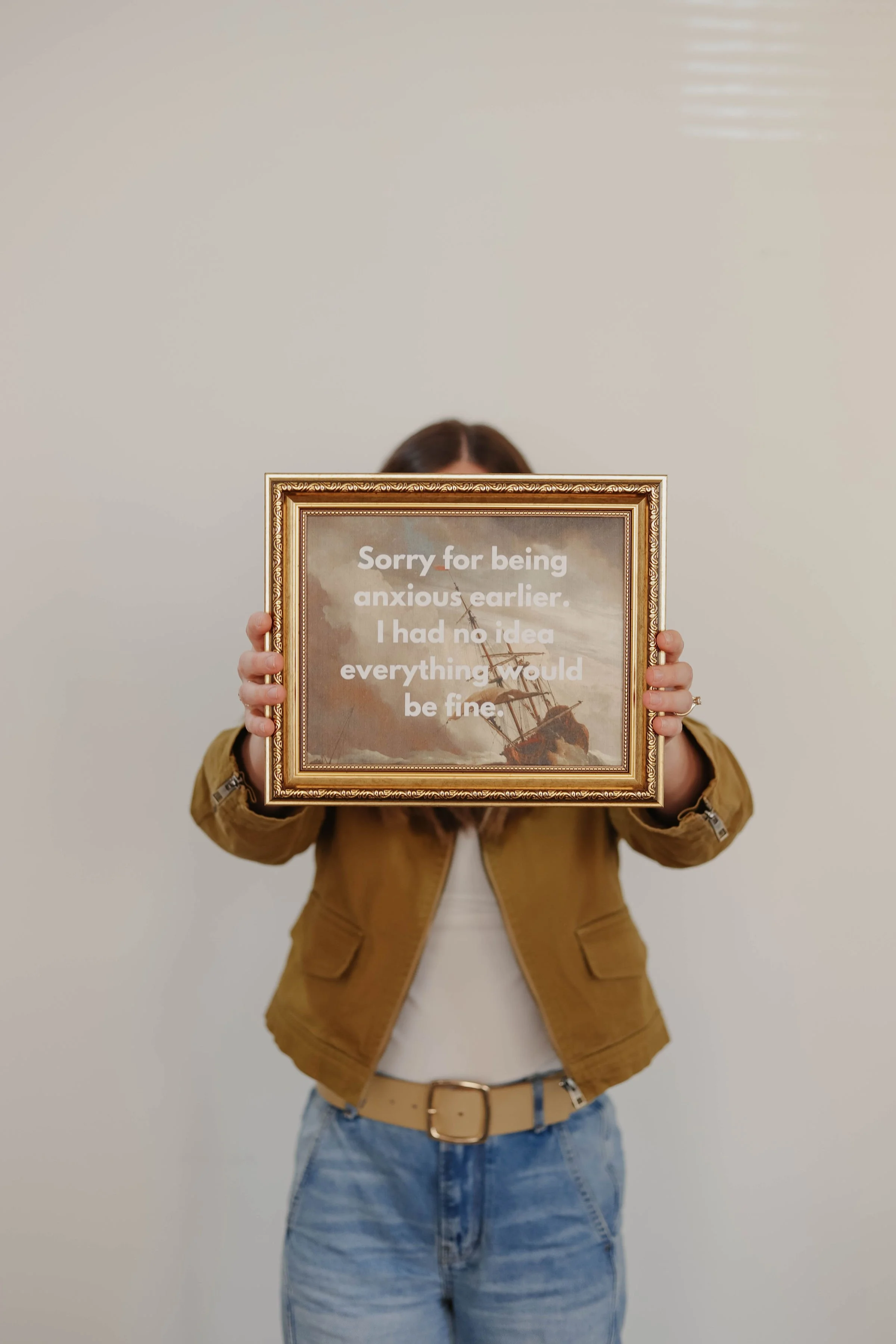 Therapy for Obsessive Compulsive Disorder (OCD) in Nashville TN | Josie holding a framed sign that says "Sorry for being anxious earlier. I had no idea everything would be fine."