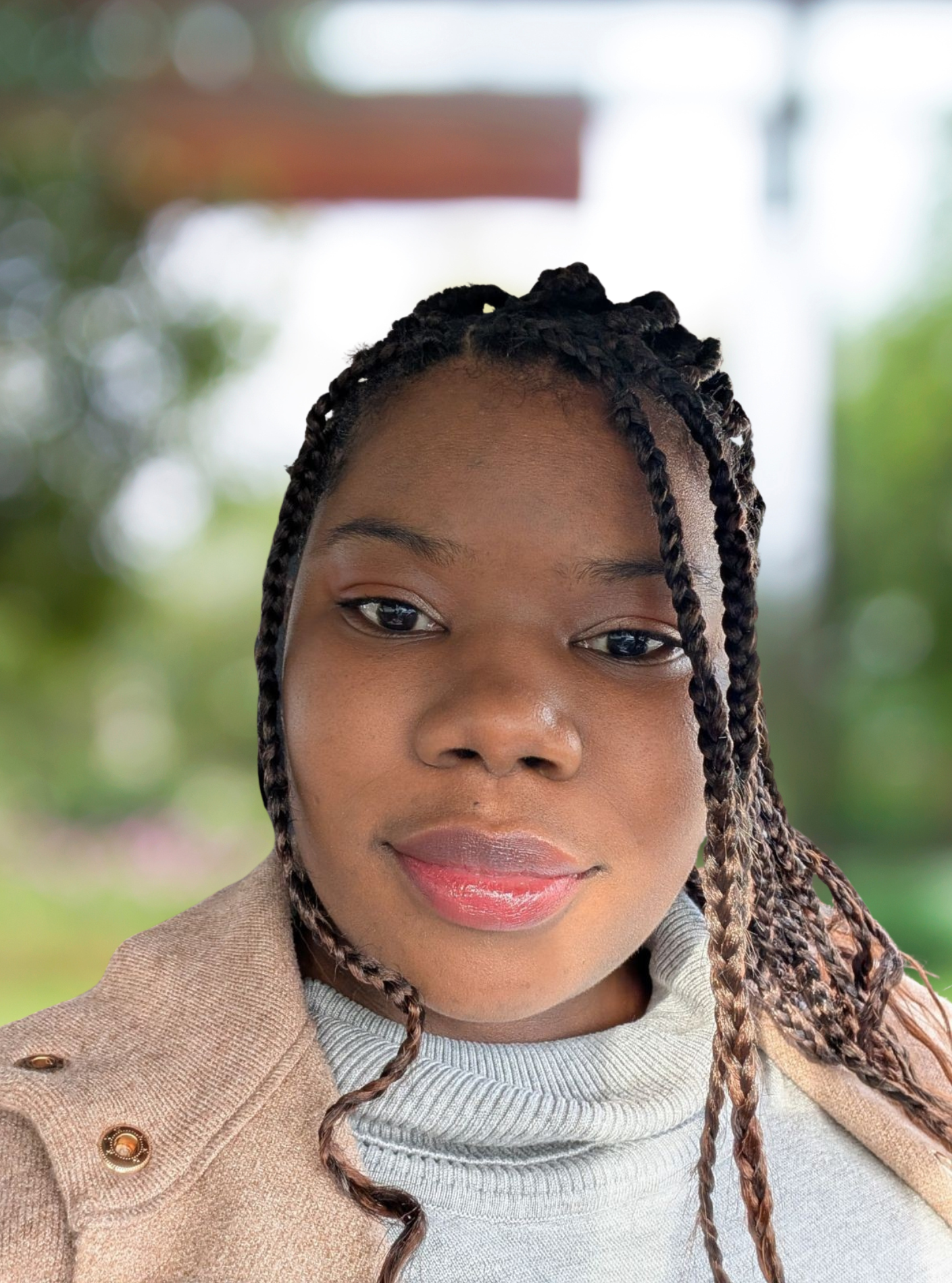 Black female therapist, Britney Thomas (LMFT) smiles kindly