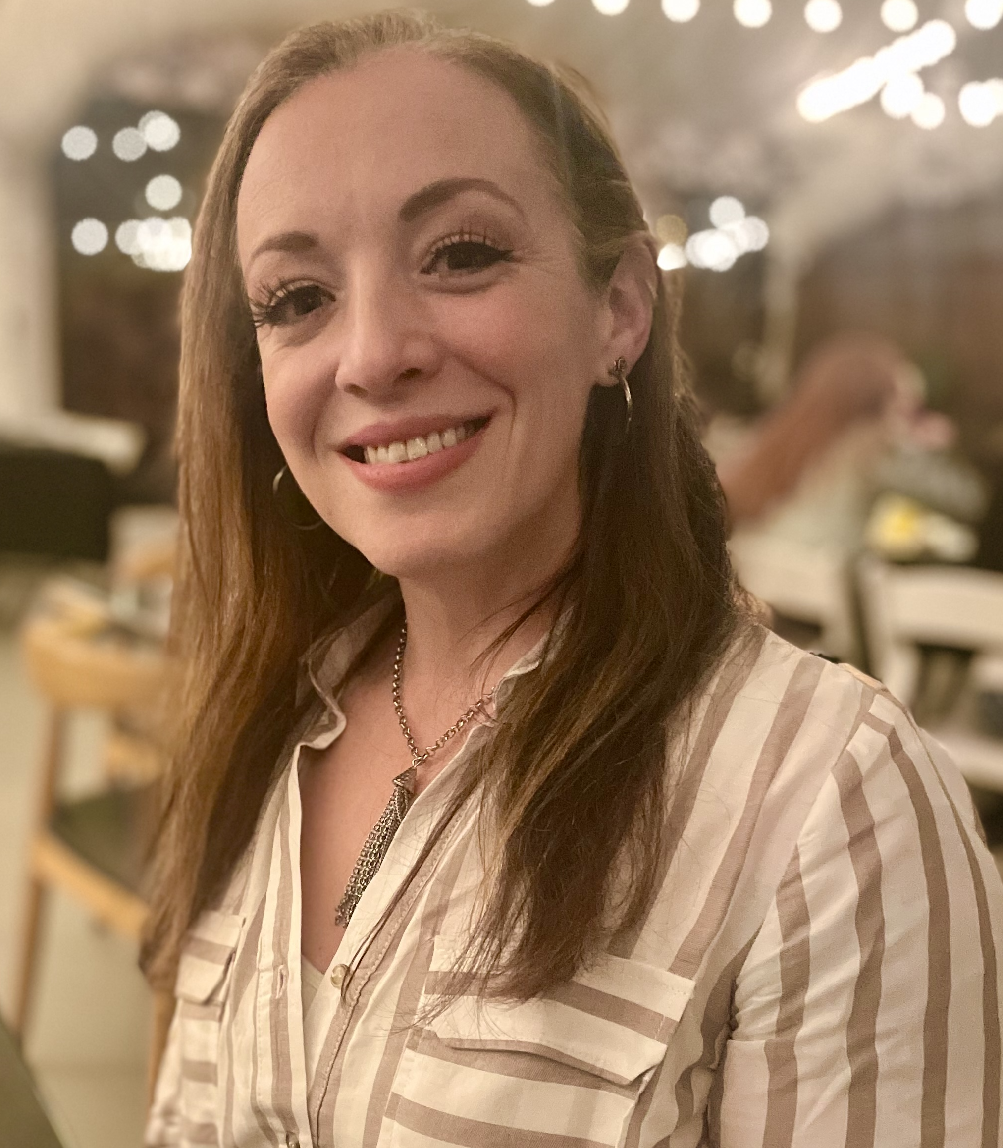 young woman smiling with brunette hair