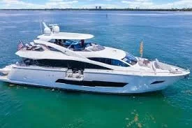 95 Sunseeker Large white and black yacht floating on calm blue water