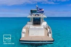 Large yacht floating on clear blue ocean with sky in the background
