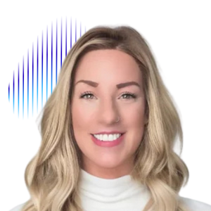 Mountain range with snow-capped peaks and a cloudy sky and some grassland in the foreground.