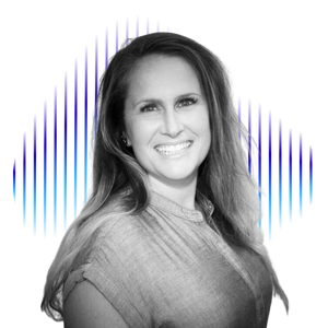 A landscape of mountains and a lake with green and brown rolling hills in the foreground, under a cloudy sky.