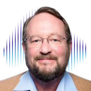 A man with glasses, a beard, and short brown hair smiling, wearing a light blue shirt and a tan blazer, against a colorful background with blue and purple digital wave patterns.