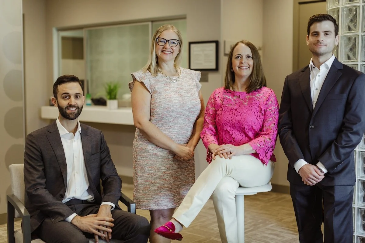 Surgical team in the lobby of the Center for Oral Surgery + Dental Implants