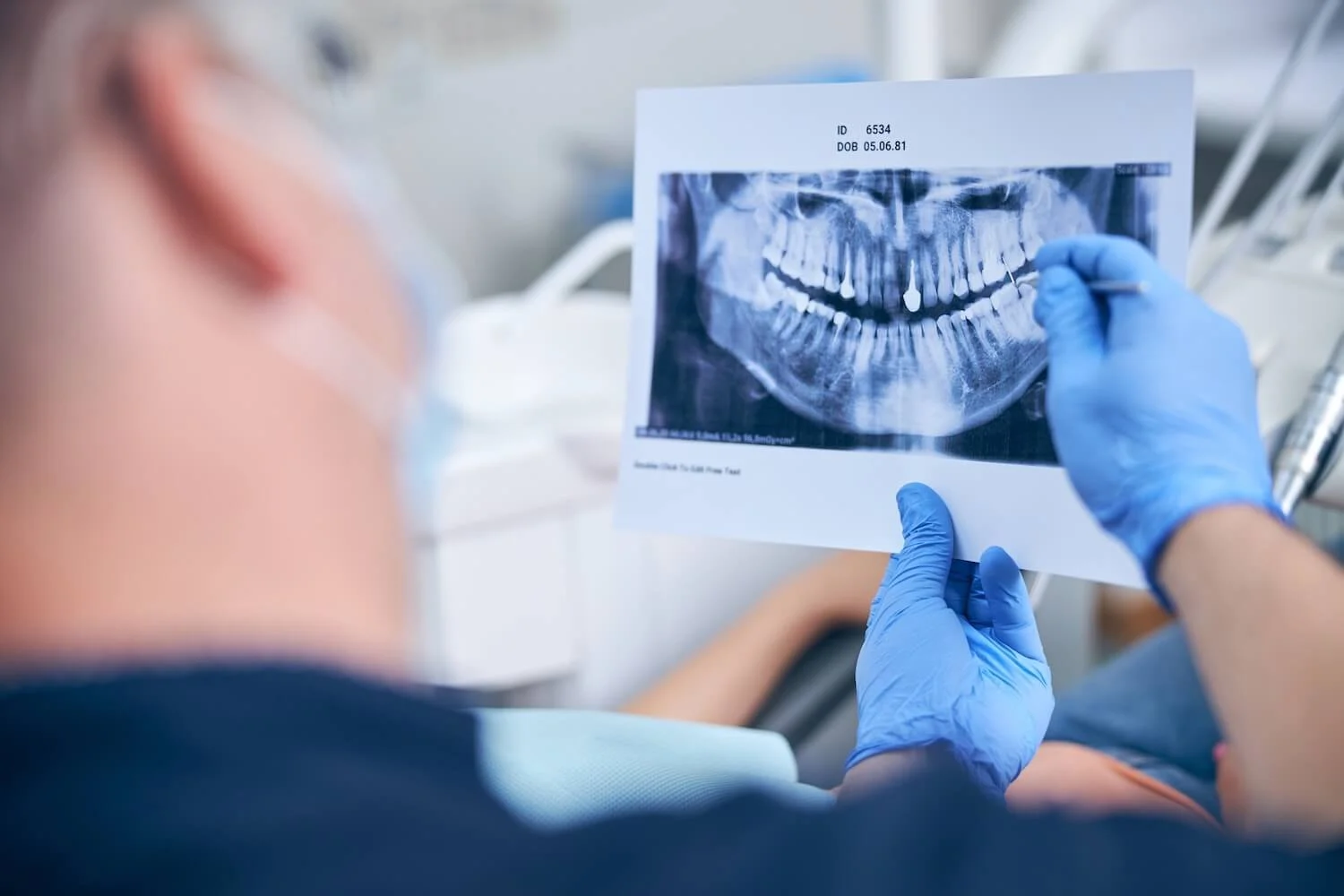 Male surgeon explaining dental implants to a patient
