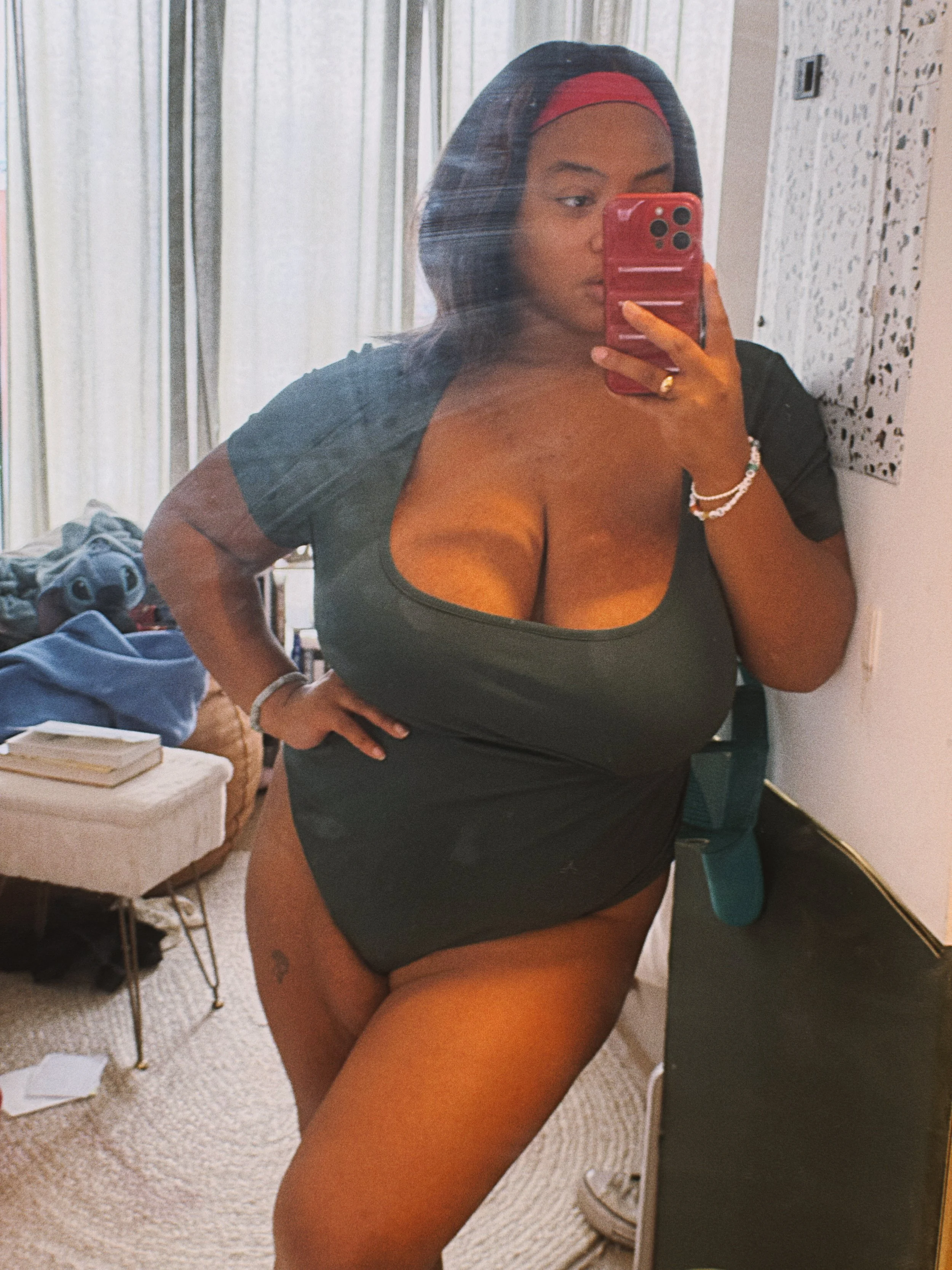 happiness is a green bodysuit that is slightly too big