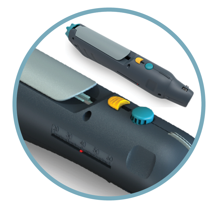 Close-up of a label maker with a tape cartridge and a handheld electronic device on a white surface.