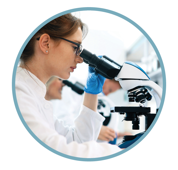 A scientist in a laboratory looking through a microscope.