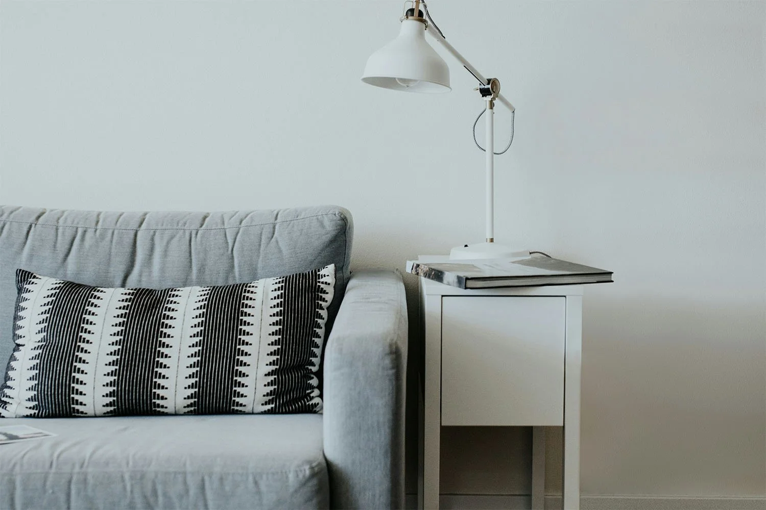 Peaceful minimalist therapy space with cozy sofa and lamp creating a calm healing environment for clients