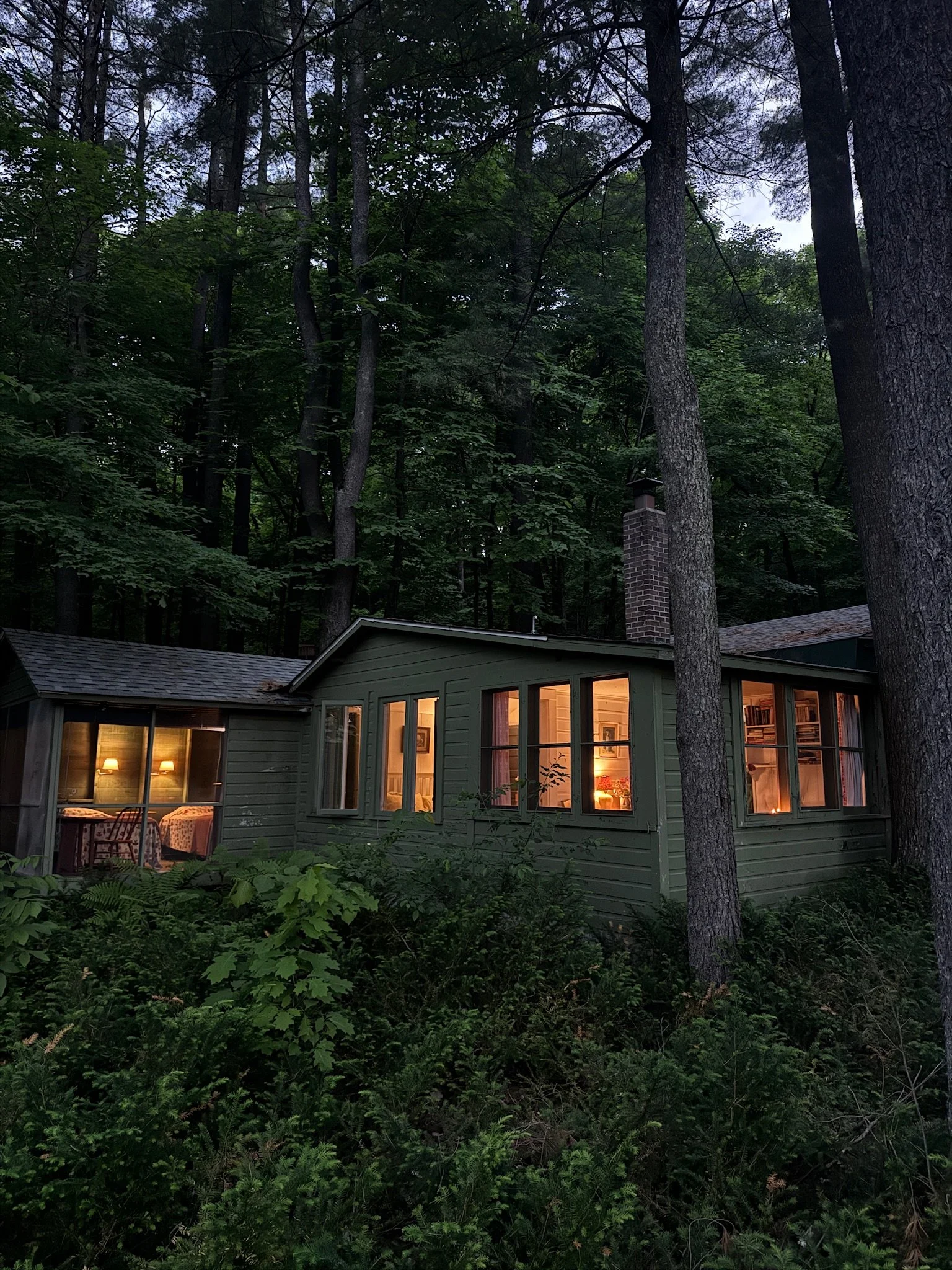 Photo of the vintage river cabin at dusk  