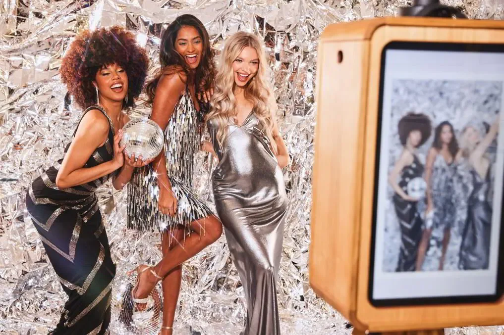 Beautiful women posing in a photo booth at a luxury event